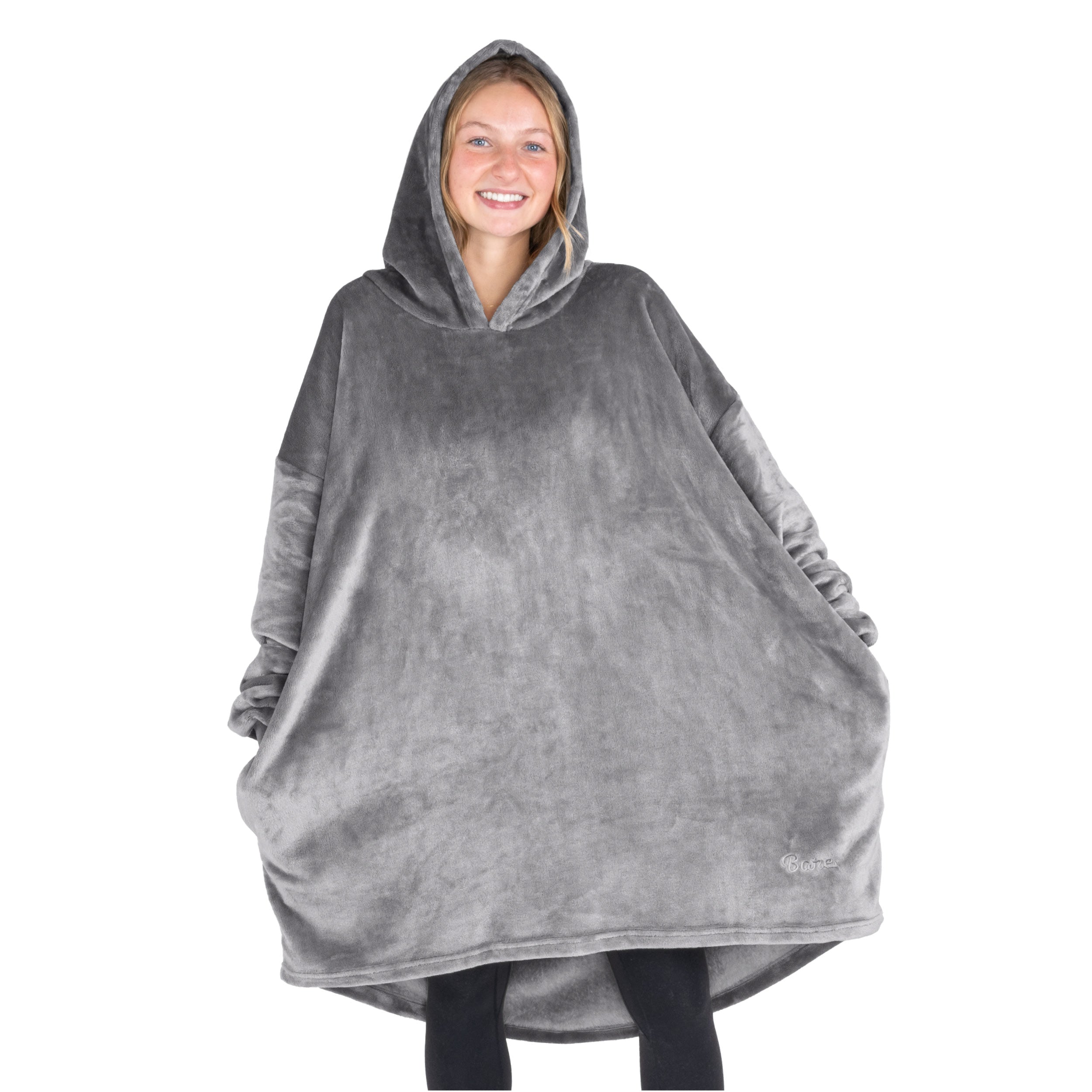 A woman standing with a wearable blanket on