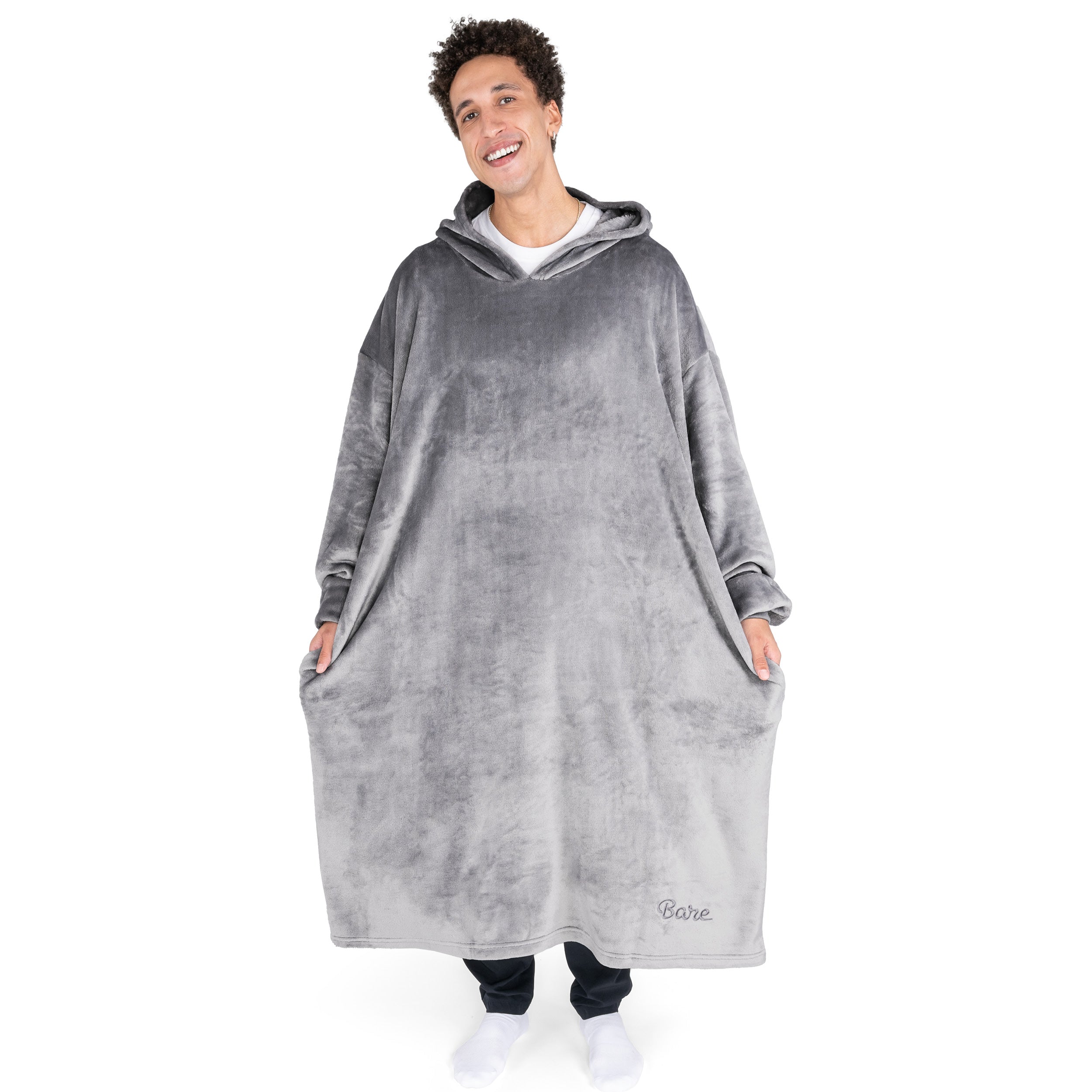 An adult with long microplush wearable blanket on