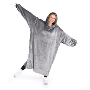 A woman has a hooded wearable blanket on