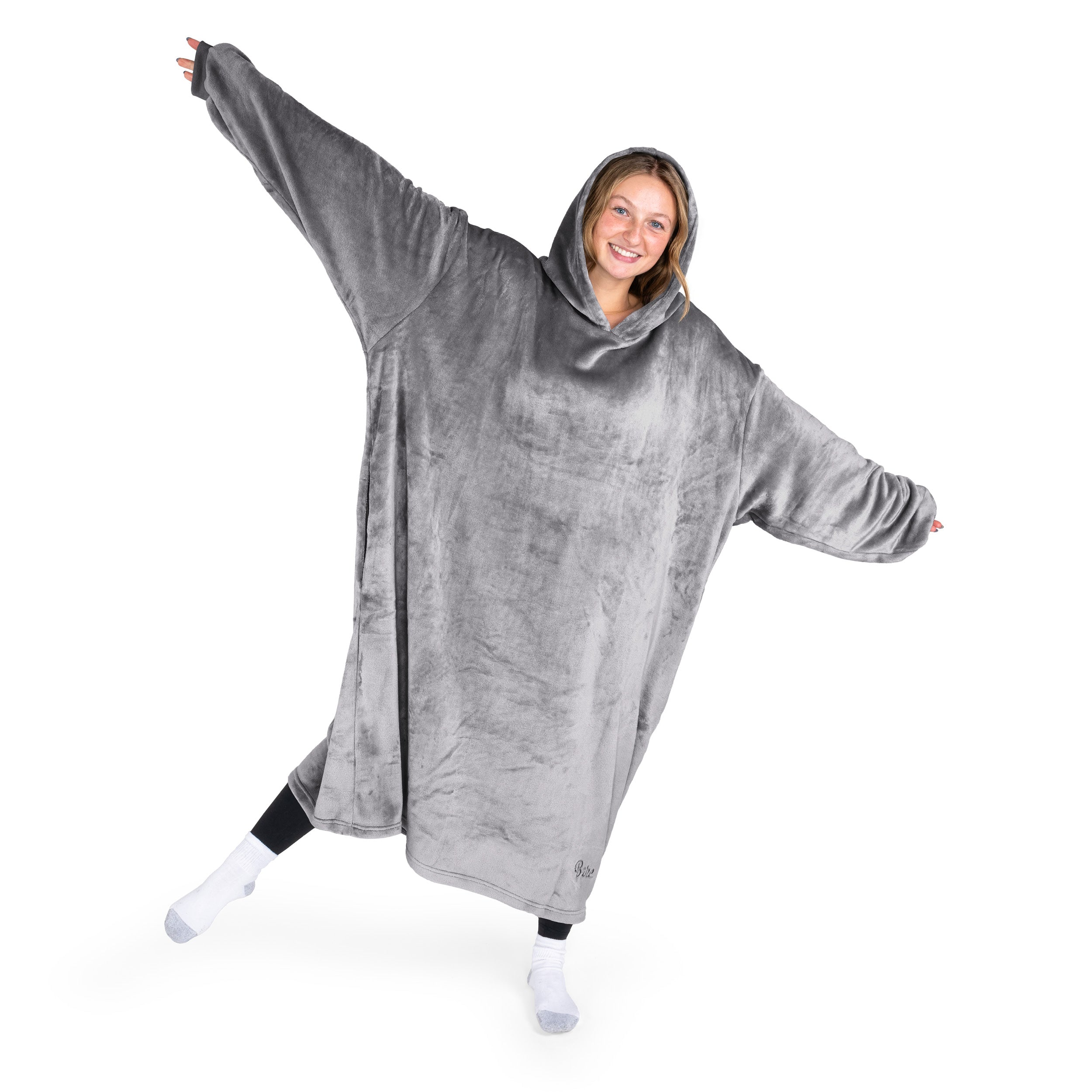 A woman has a hooded wearable blanket on