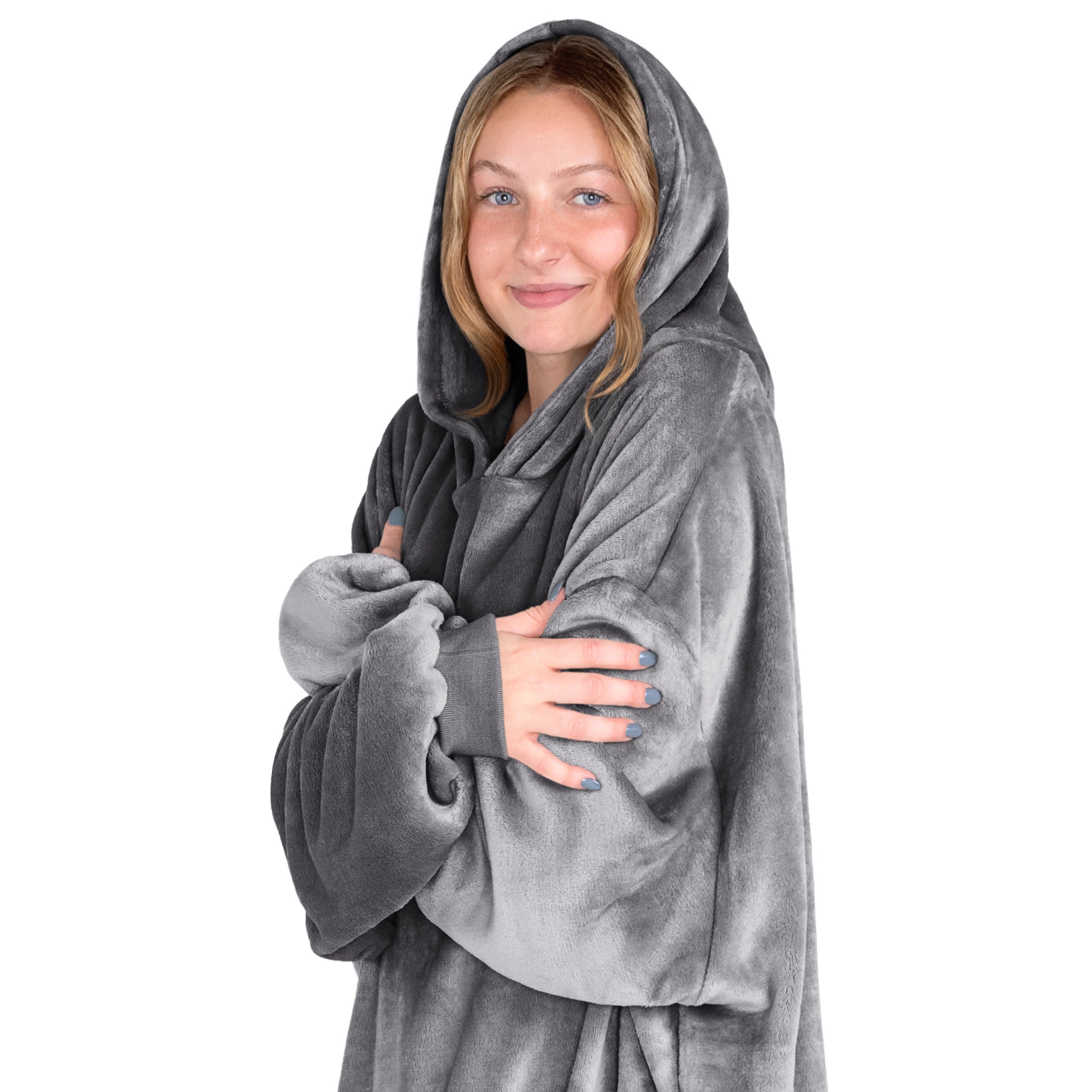A woman is snuggled up in microplush wearable blanket