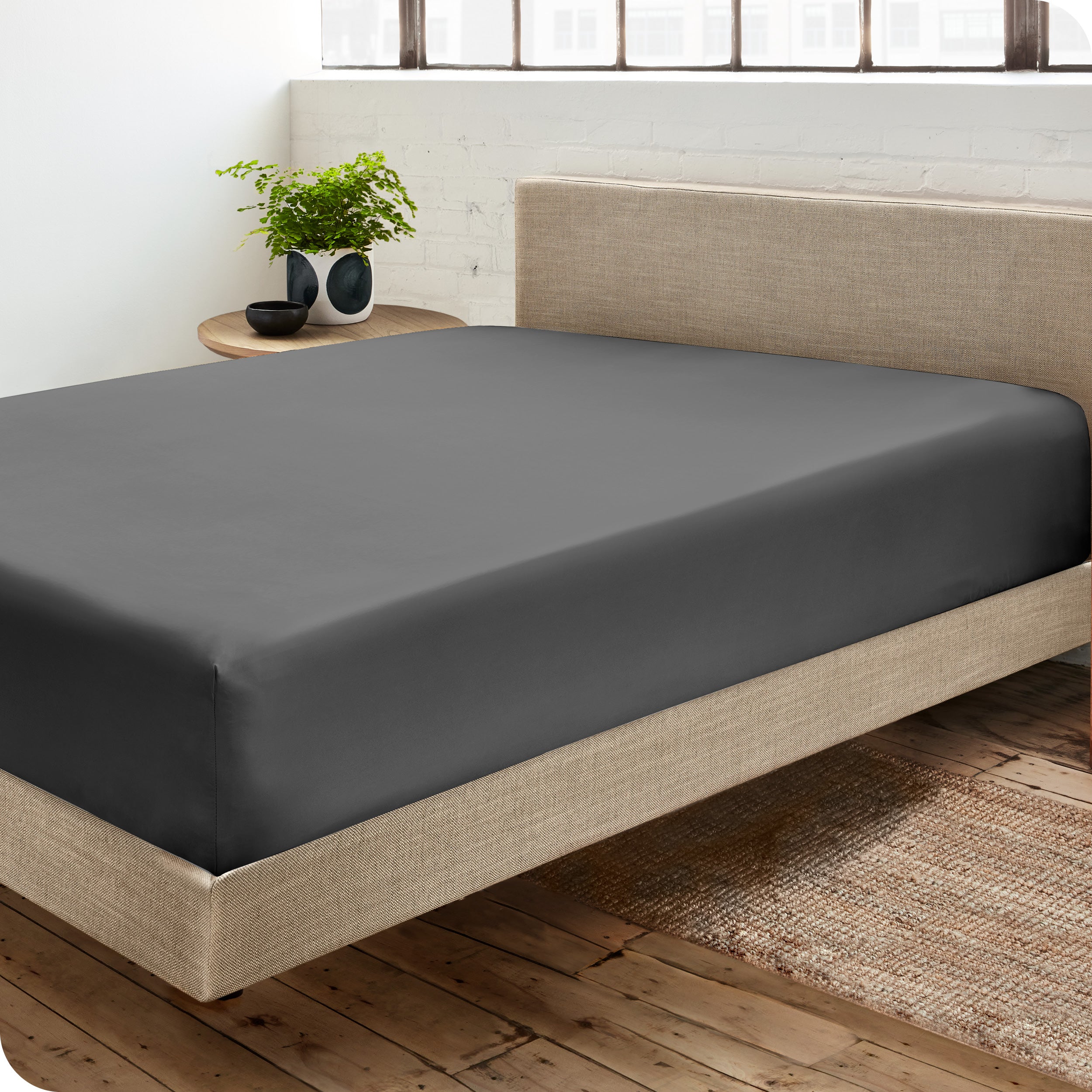 A sateen fitted sheet on a bed