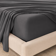 Organic flannel sheets on a beige bed frame