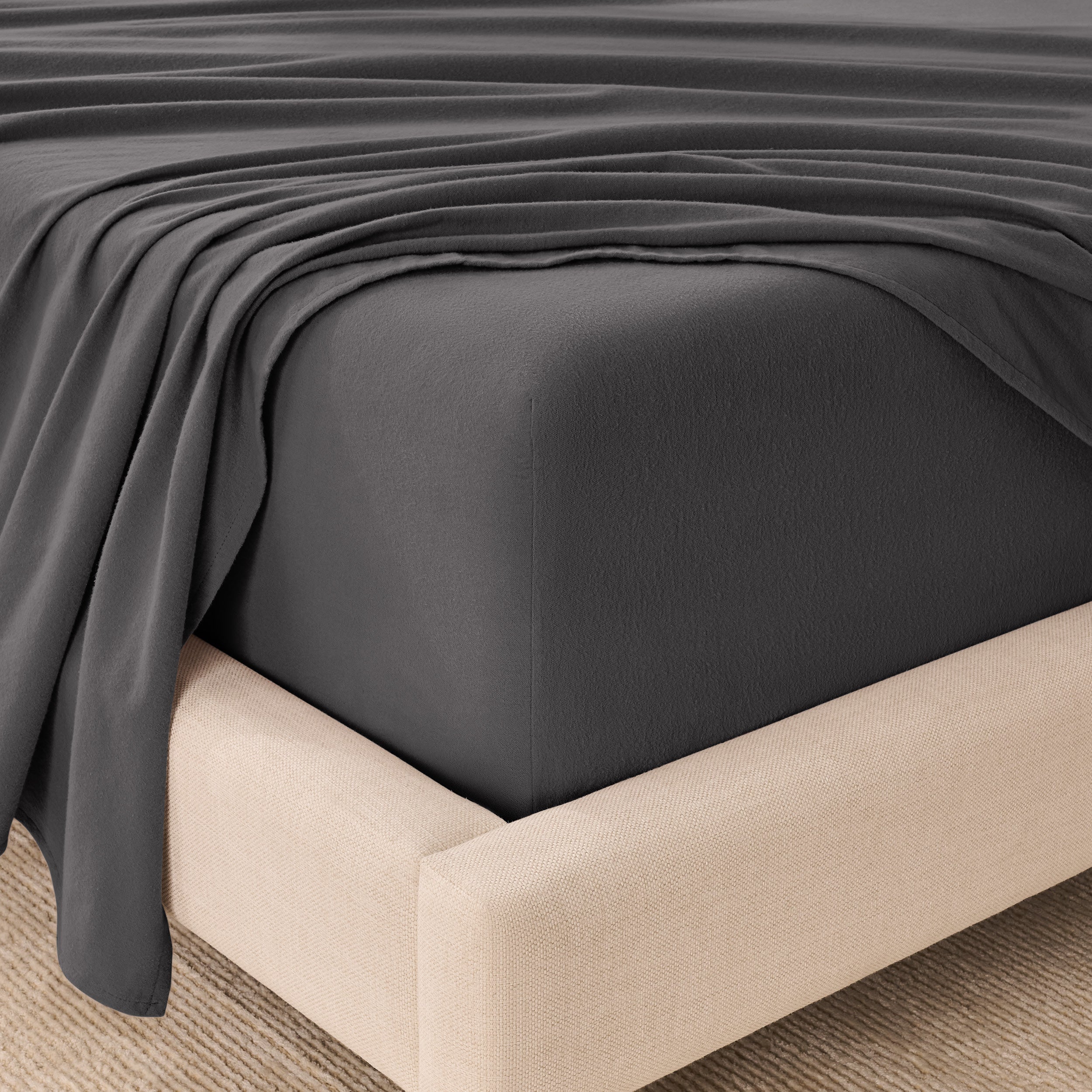 Organic flannel sheets on a beige bed frame