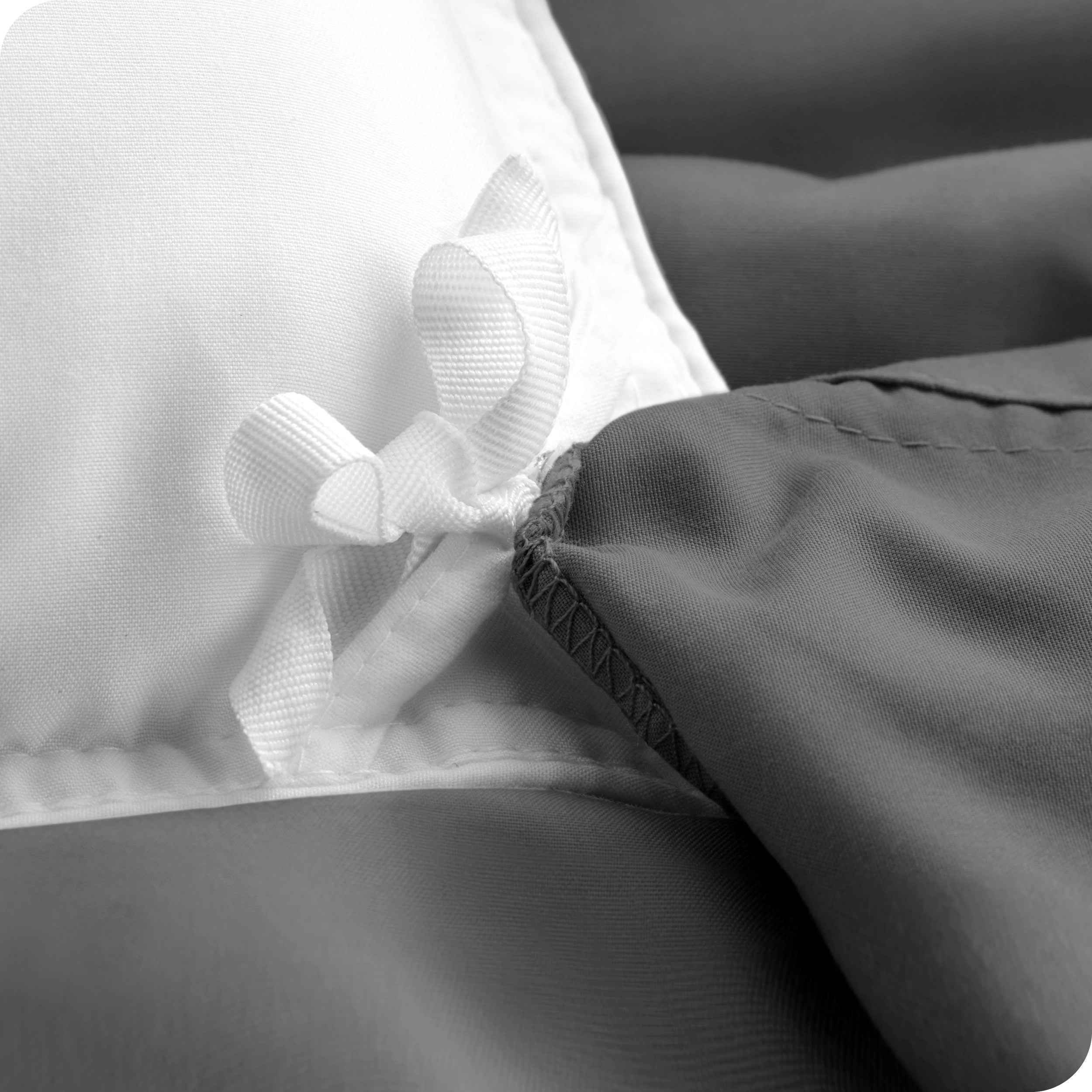 The corner ties of a duvet cover attached to a duvet insert