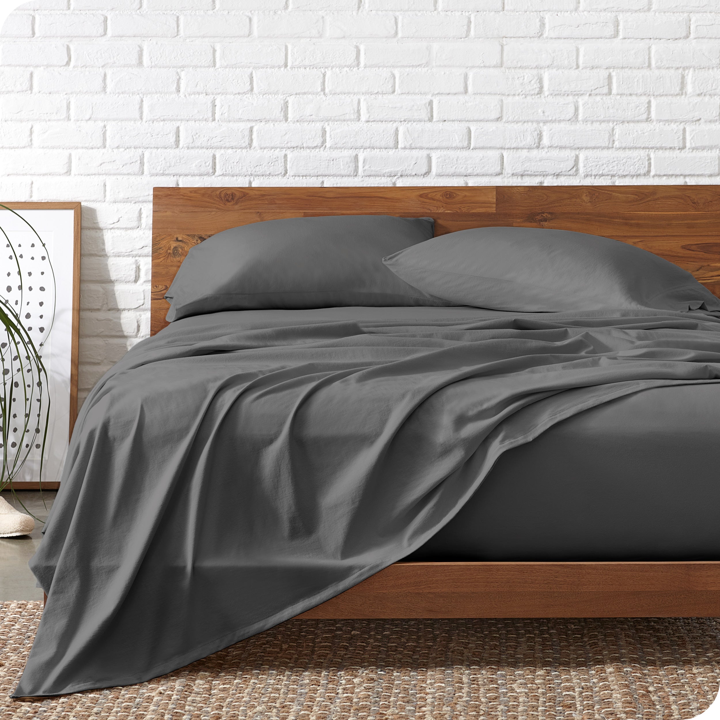 Organic jersey sheets on a bed with a wooden bed frame