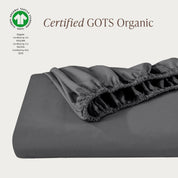 A single fitted sheet folded neatly showing part of the elastic. The fitted sheet is Certified GOTS Organic.