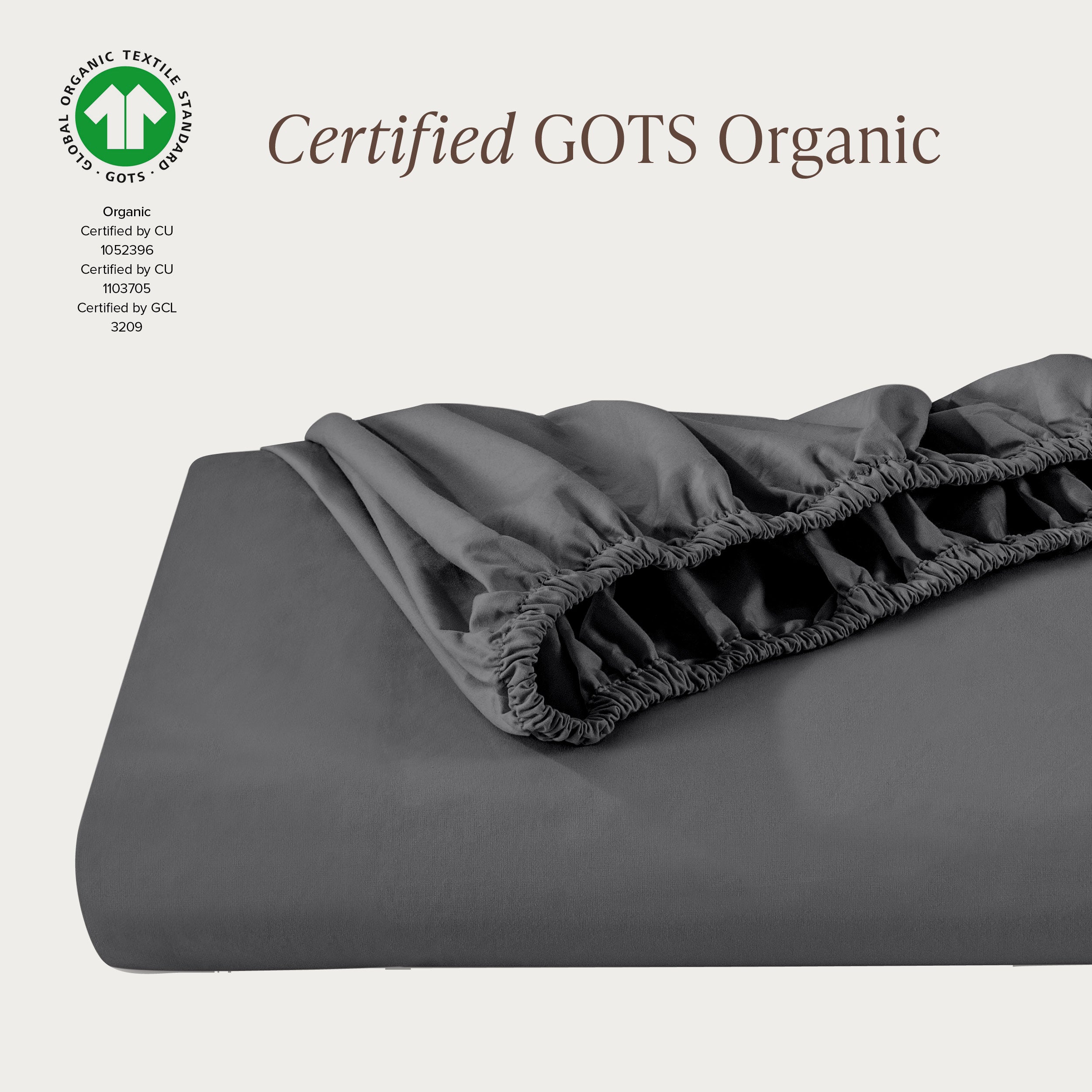A single fitted sheet folded neatly showing part of the elastic. The fitted sheet is Certified GOTS Organic.