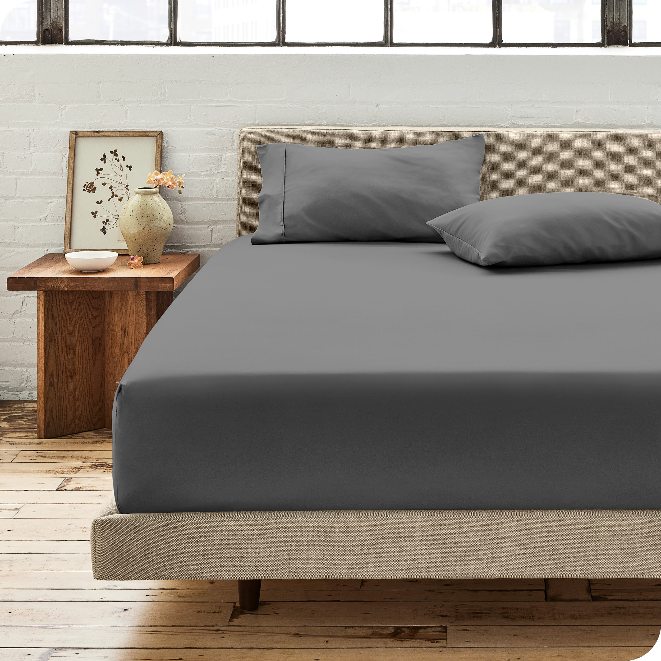 Percale fitted sheet on a mattress with matching pillowcases on pillows