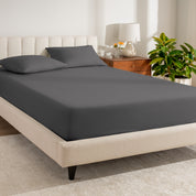 A single organic cotton percale fitted sheet on a bed