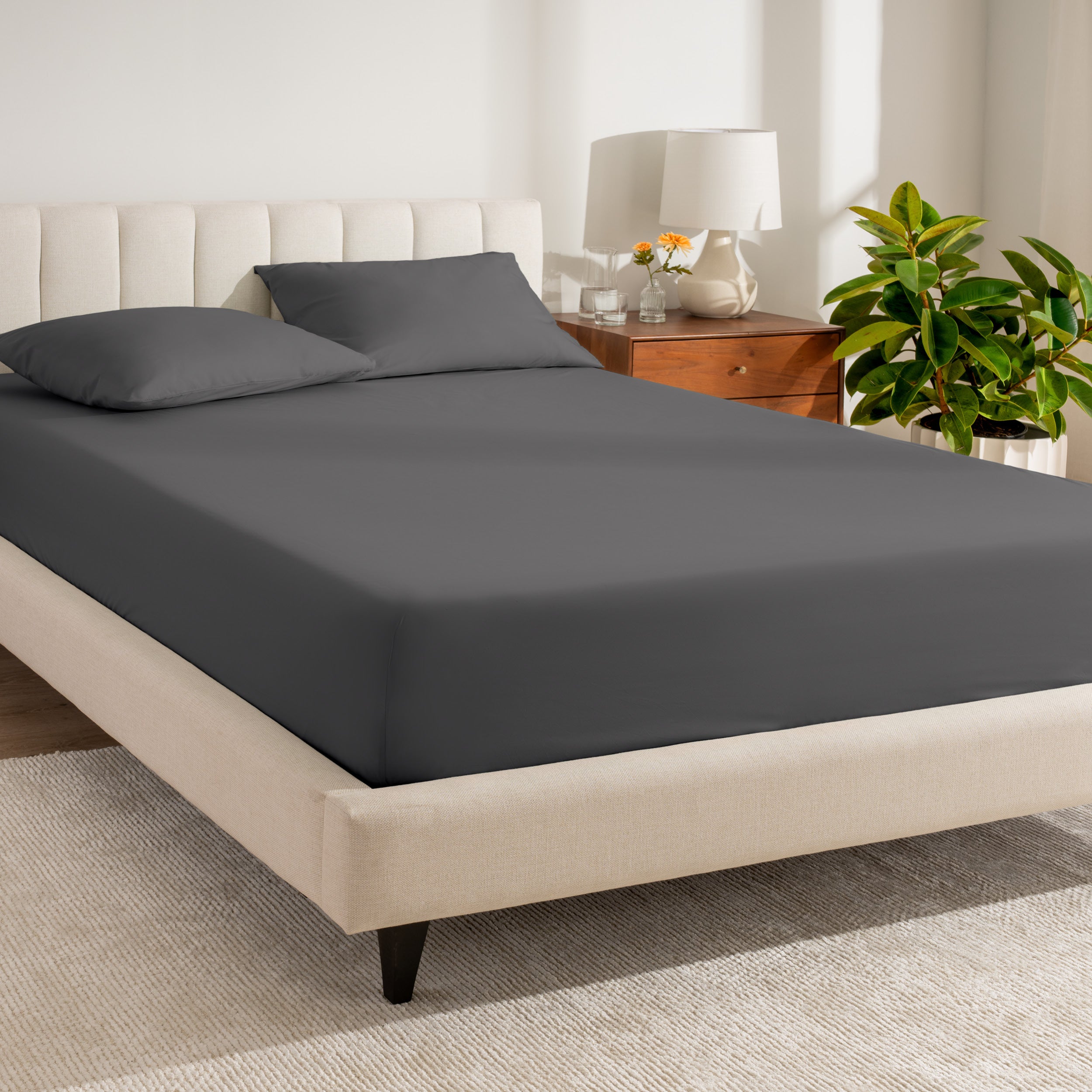 A single organic cotton percale fitted sheet on a bed