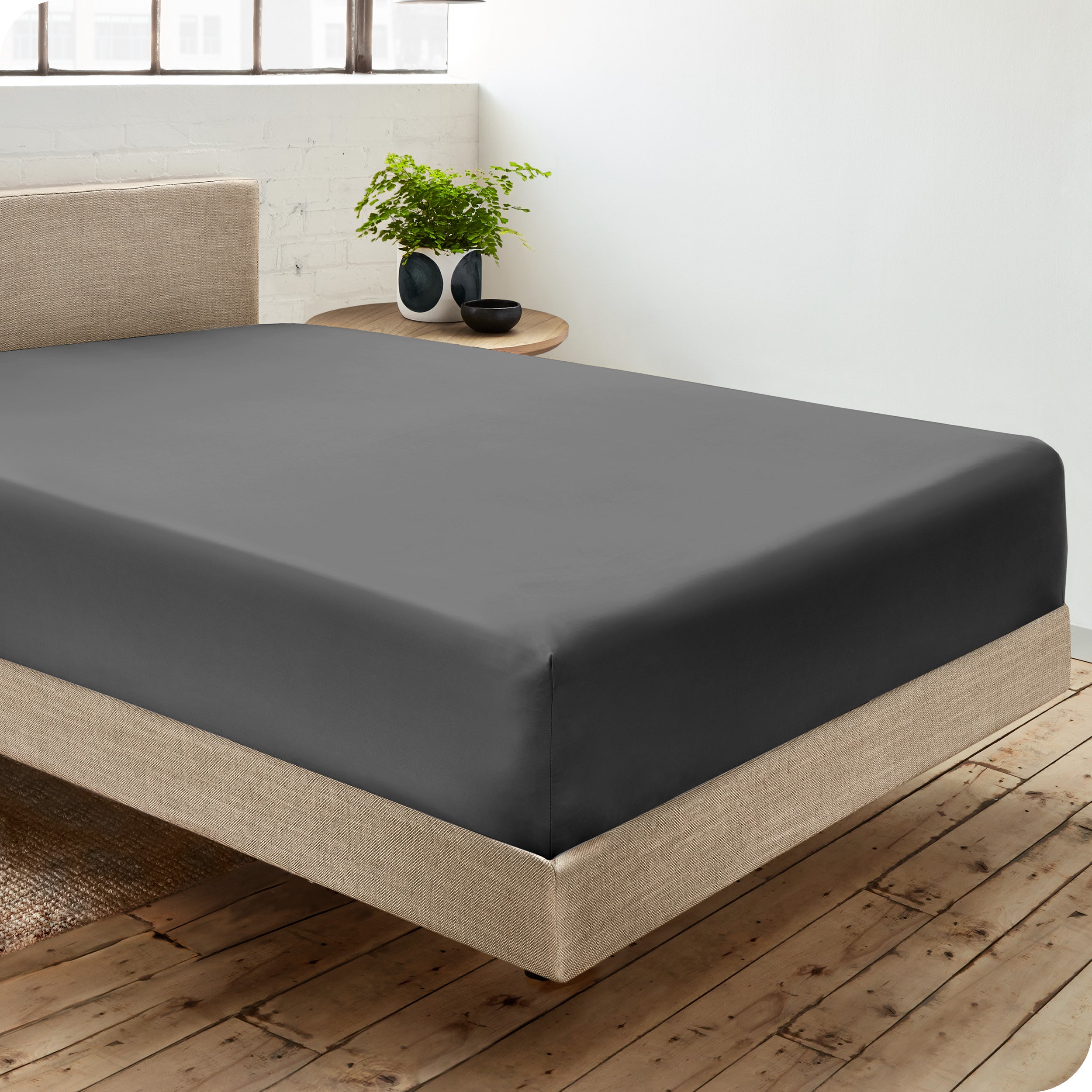A single organic cotton fitted sheet on a bed