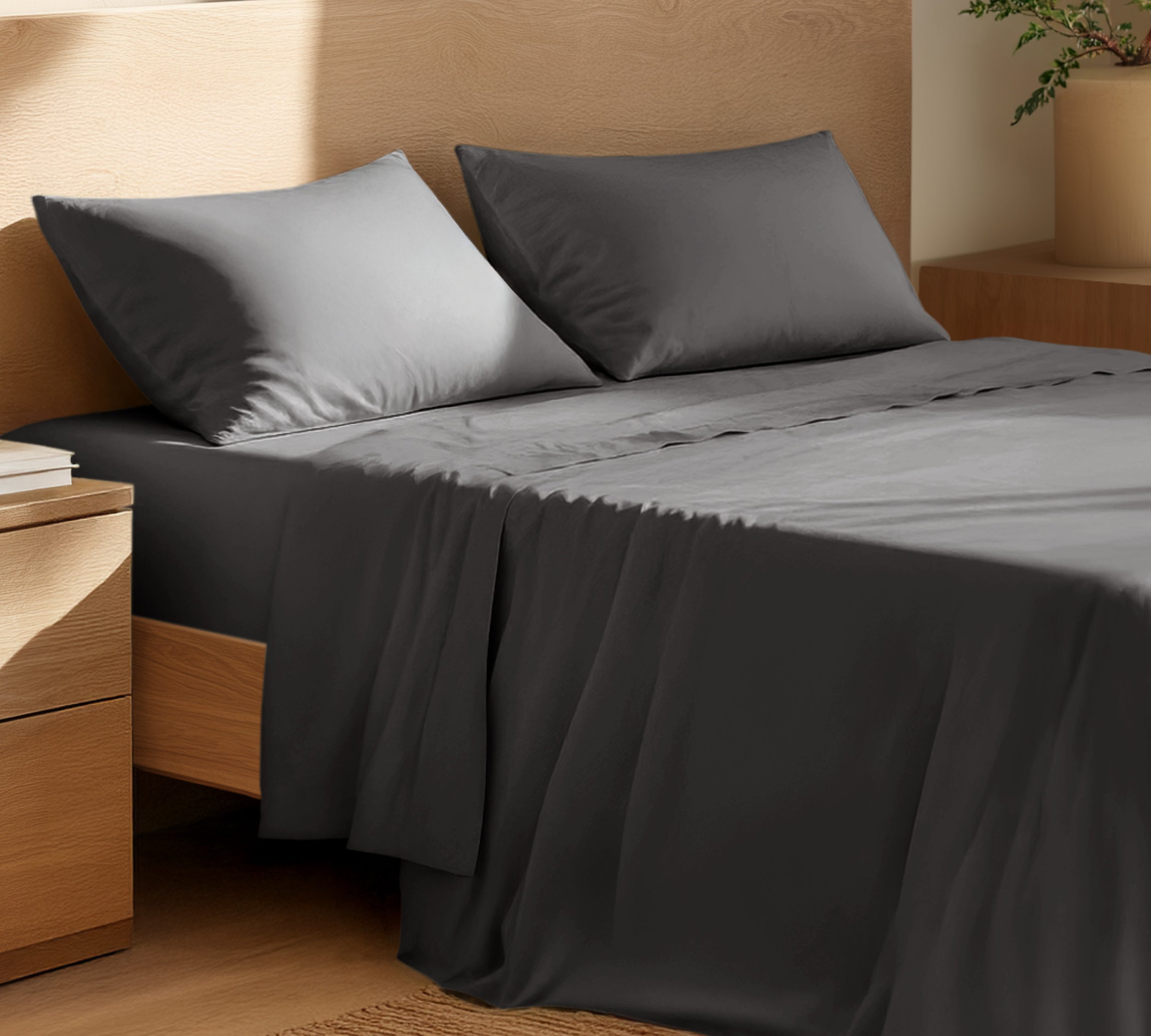 Organic cotton percale sheet set on a bed, with a flat sheet, fitted sheet, and two pillowcases displayed.