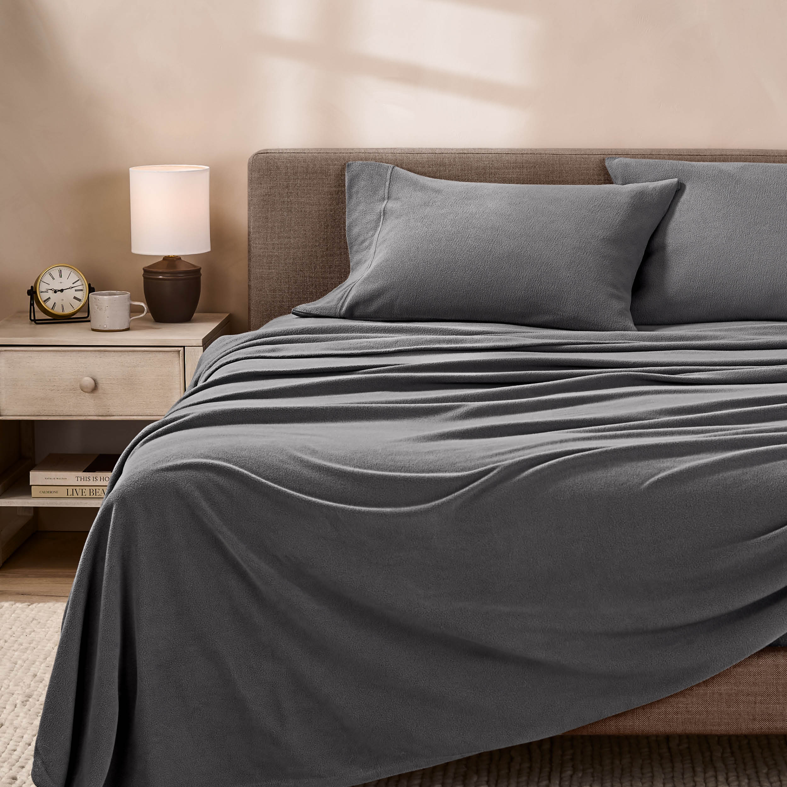 View of fleece sheets from the end of a bed with the top sheet draped over the side and end