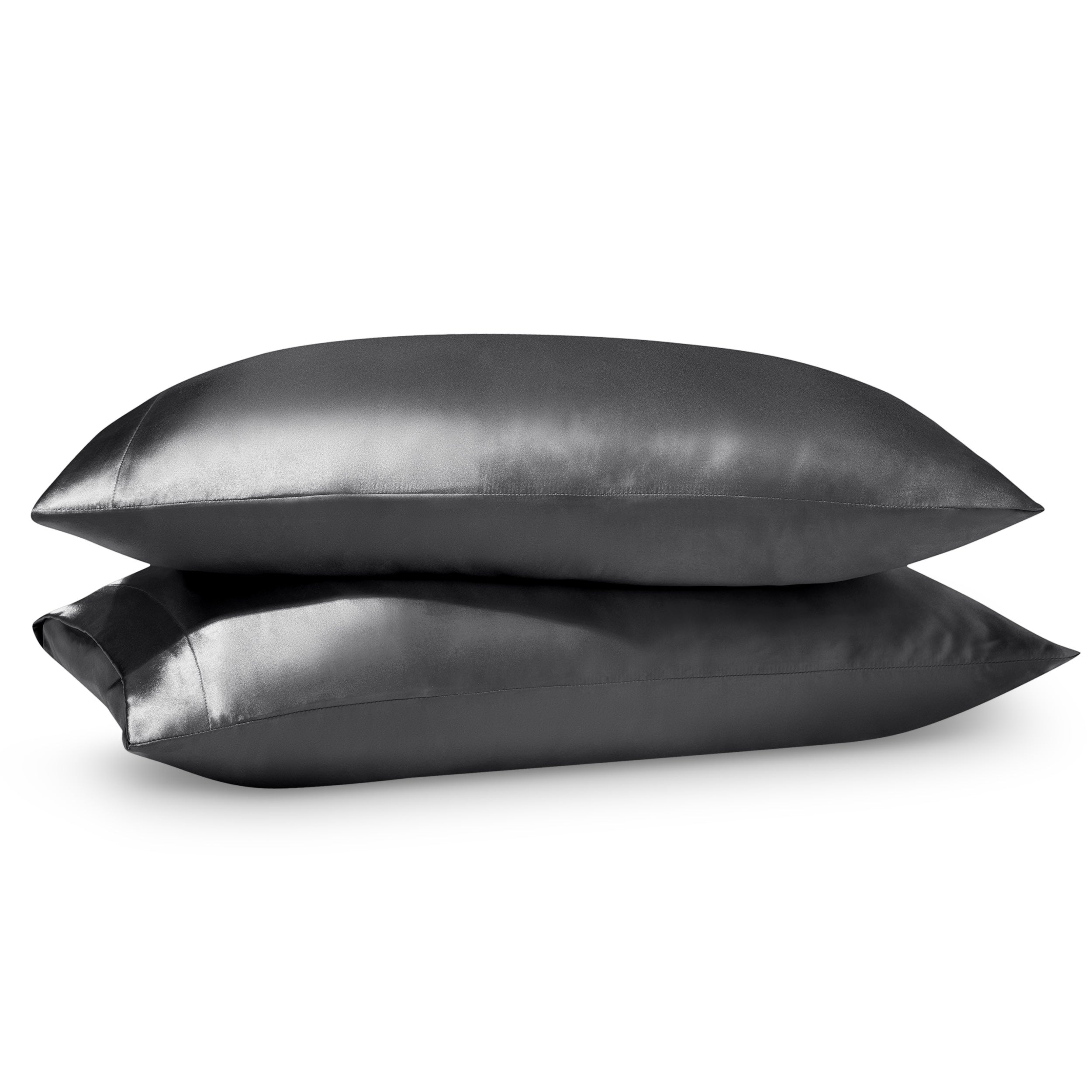 Two pillows on a white background with satin pillowcases on them.