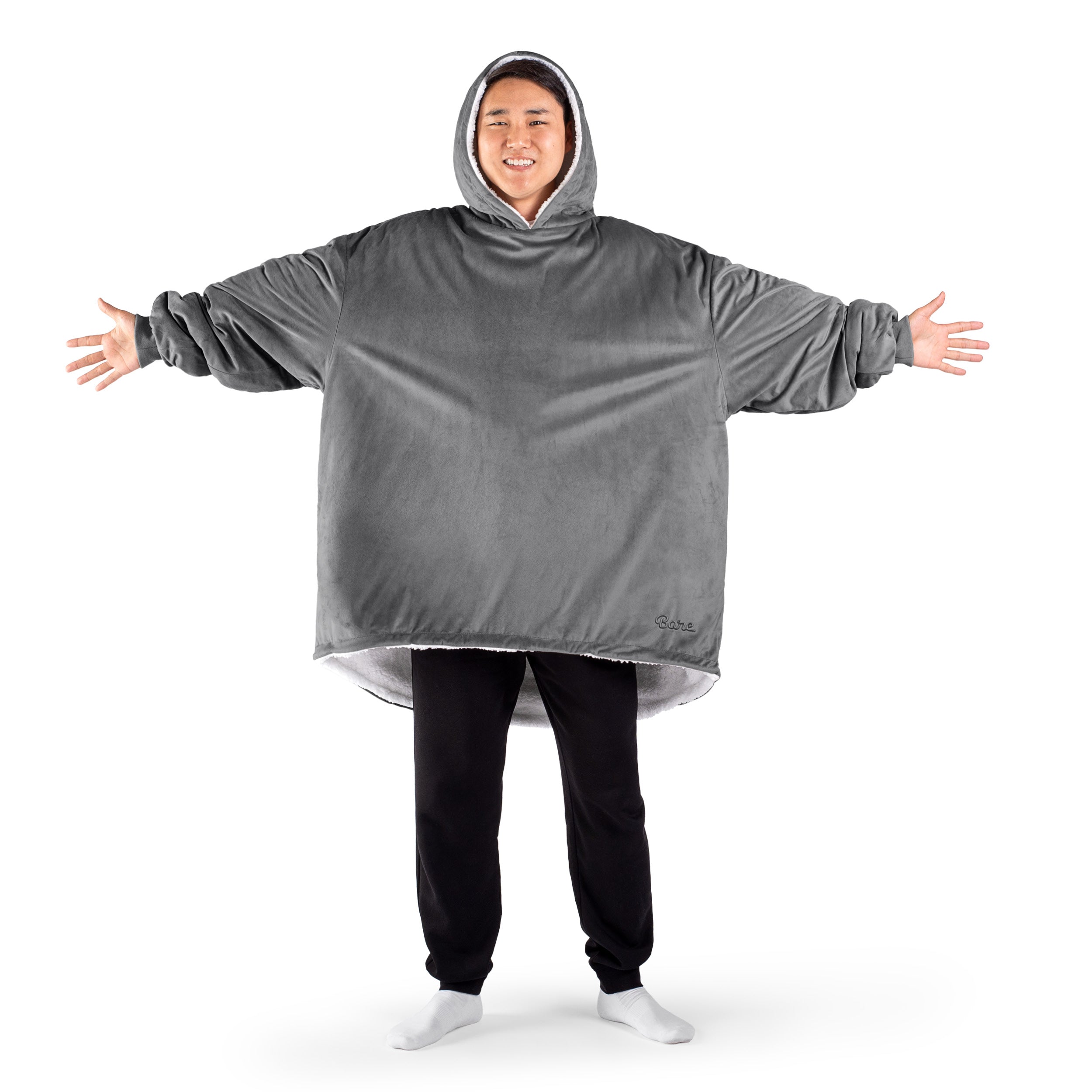 An adult with a sherpa wearable blanket on