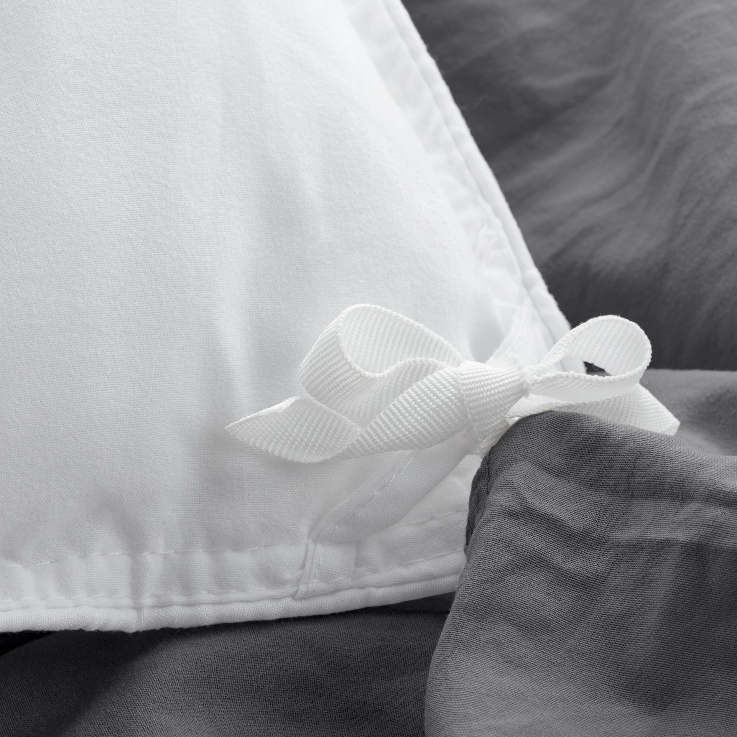 Close up of cloth ties for attaching duvet insert to inside of duvet cover