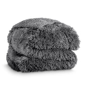 A shaggy faux fur blanket folded