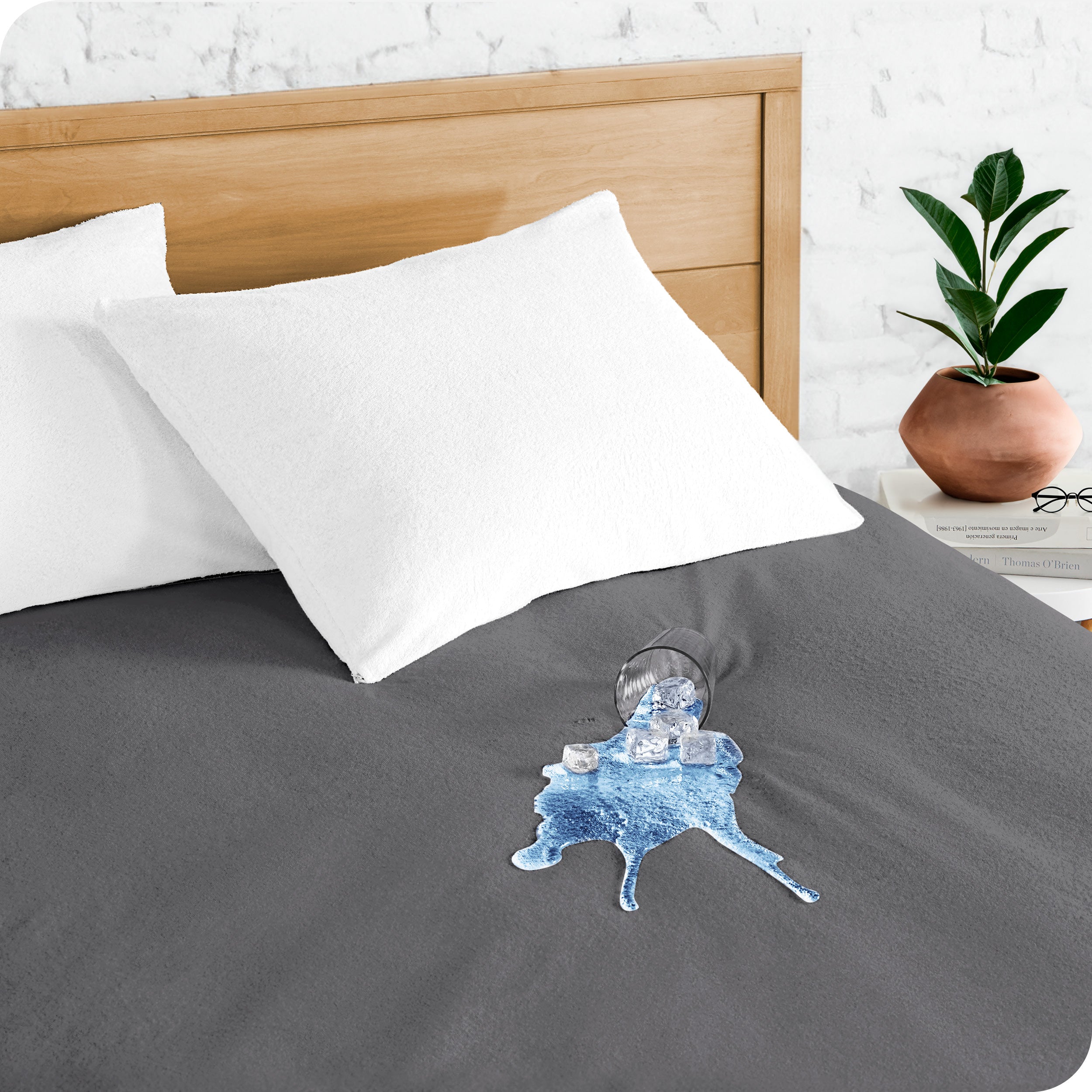 A glass of water spilled on a mattress protector