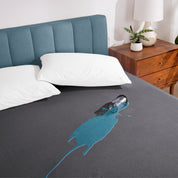 A glass of water spilled on a mattress protector