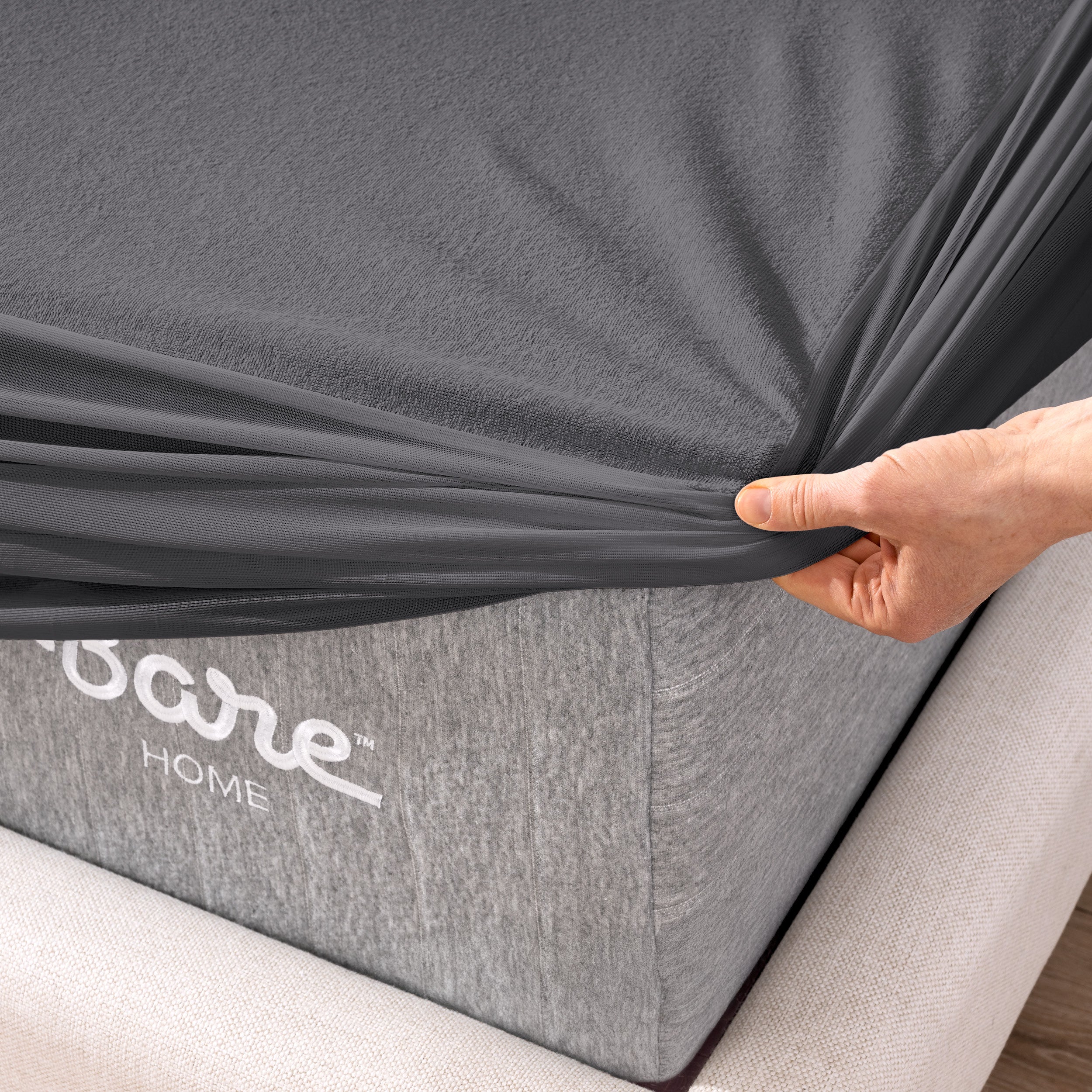 The corner of a mattress with a mattress protector putting on it