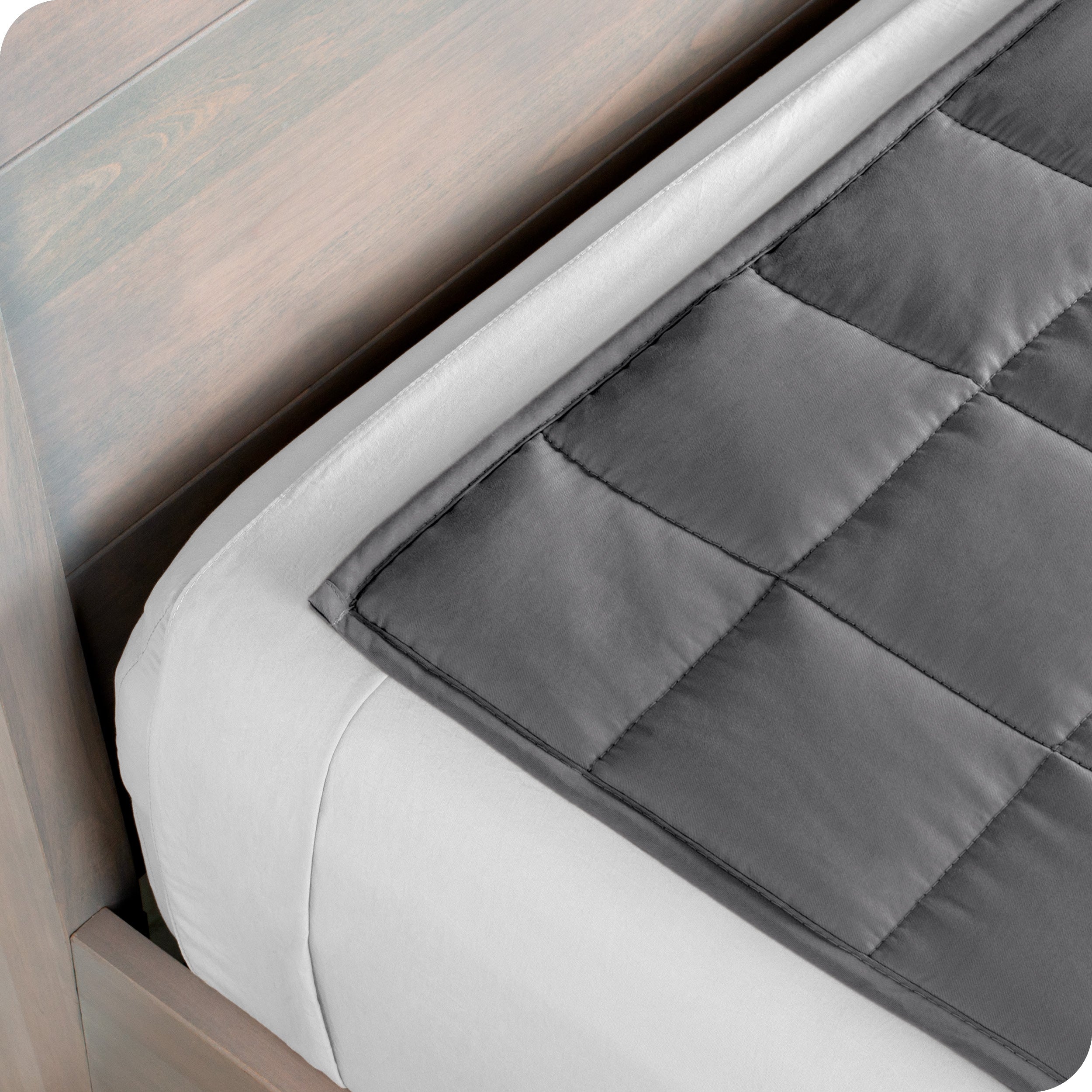 Close up of the corner of a weighted blanket on a bed