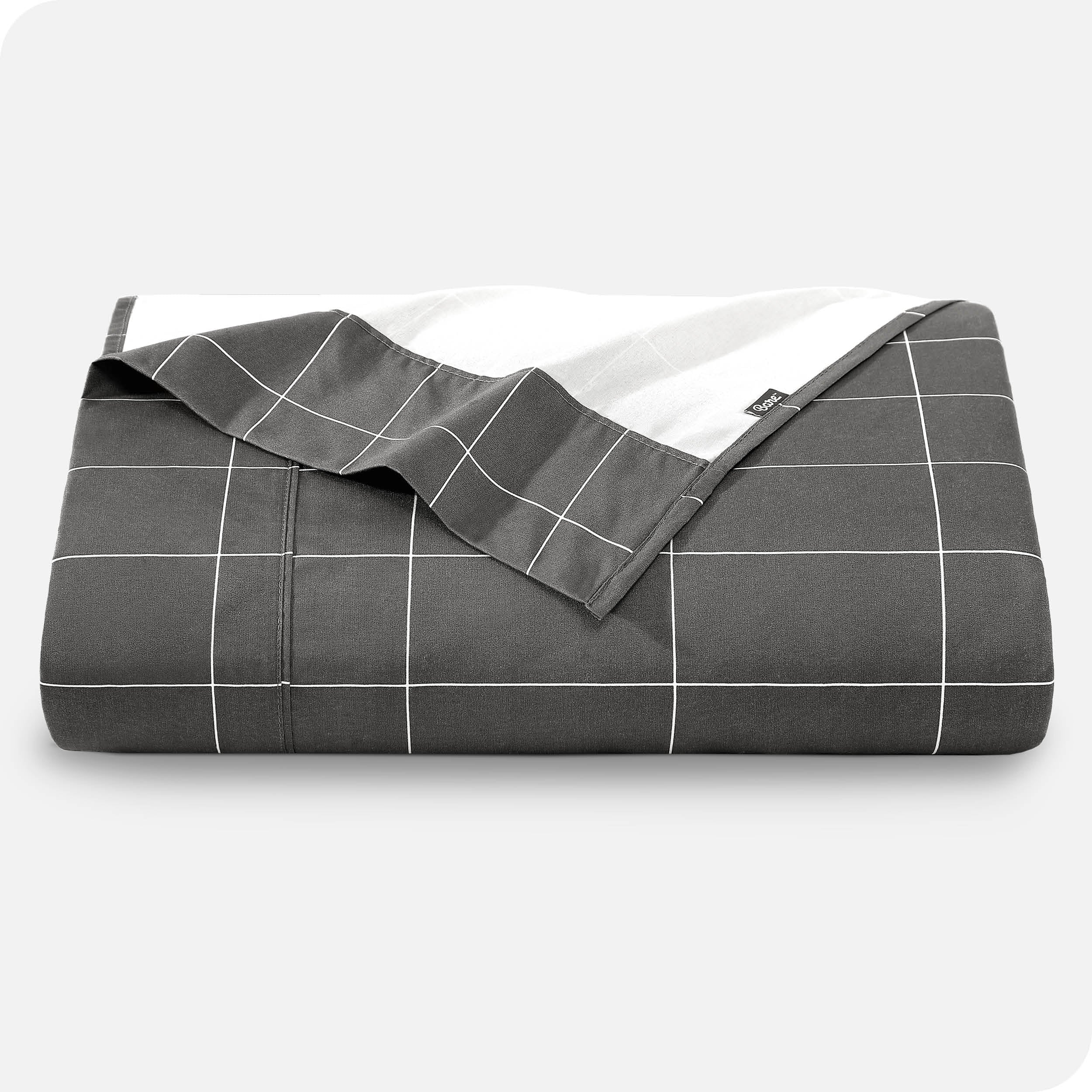 Neatly folded printed microfiber flat sheet with corner folded over. 