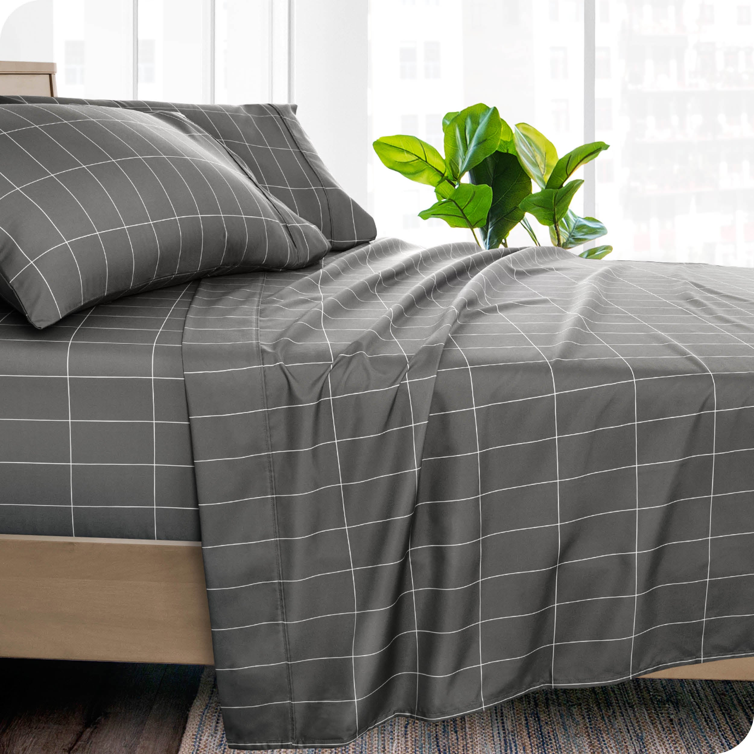 Side of a bed made with a draped microfiber flat sheet. 