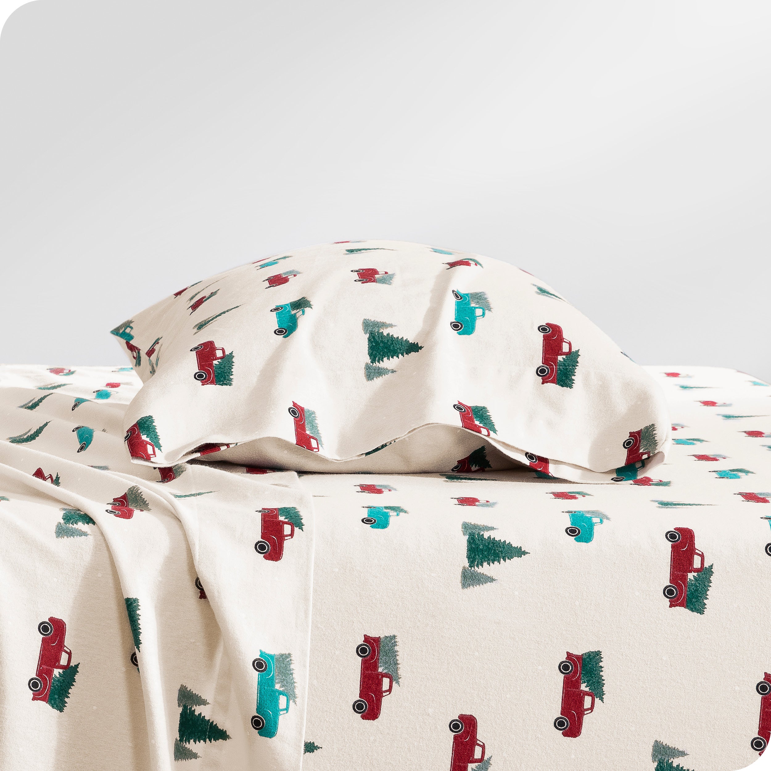 A flannel pillowcase on a pillow set on a bed with matching sheets