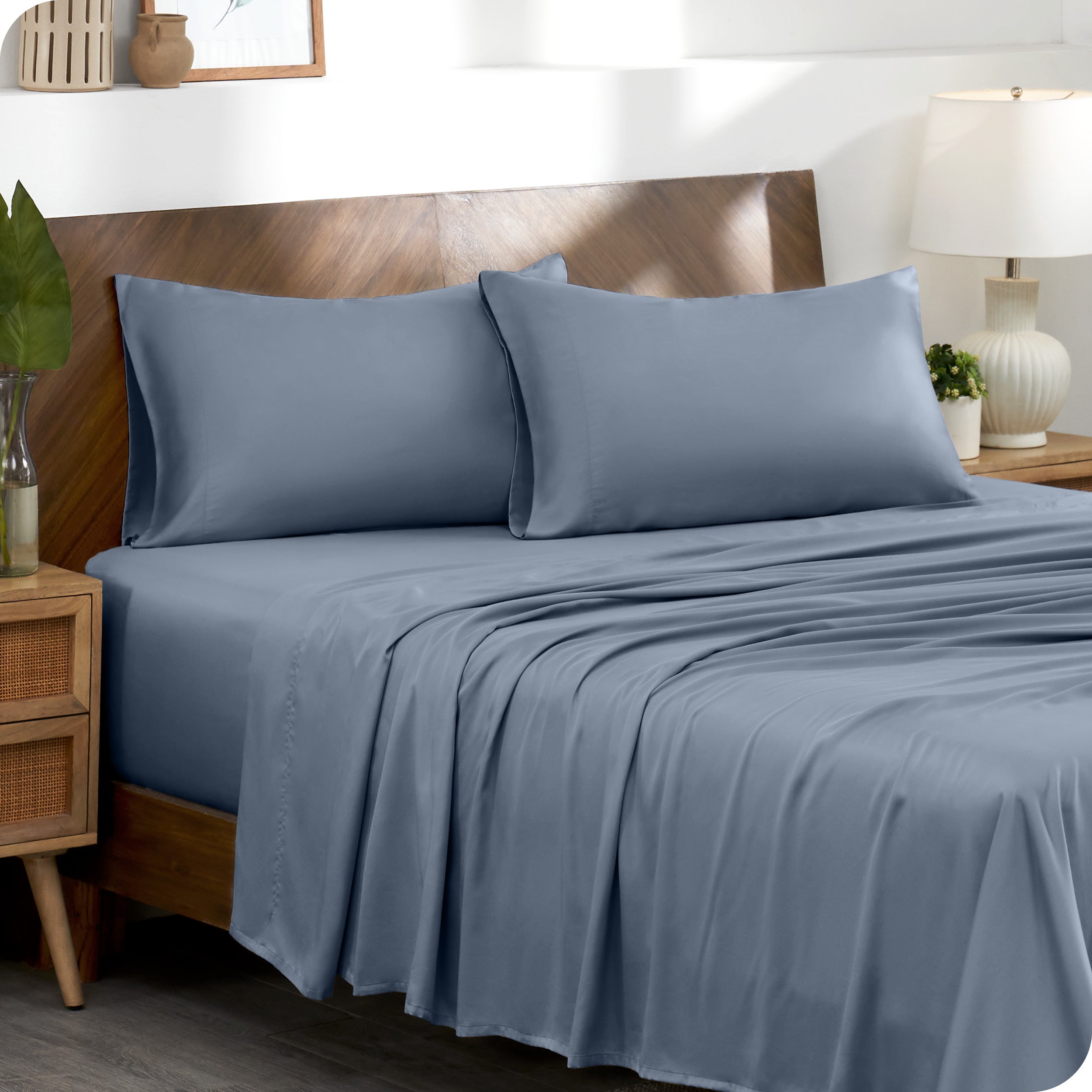 Two pillowcases on pillows on a bed with matching sheets