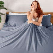 A smiling woman sitting on a bed