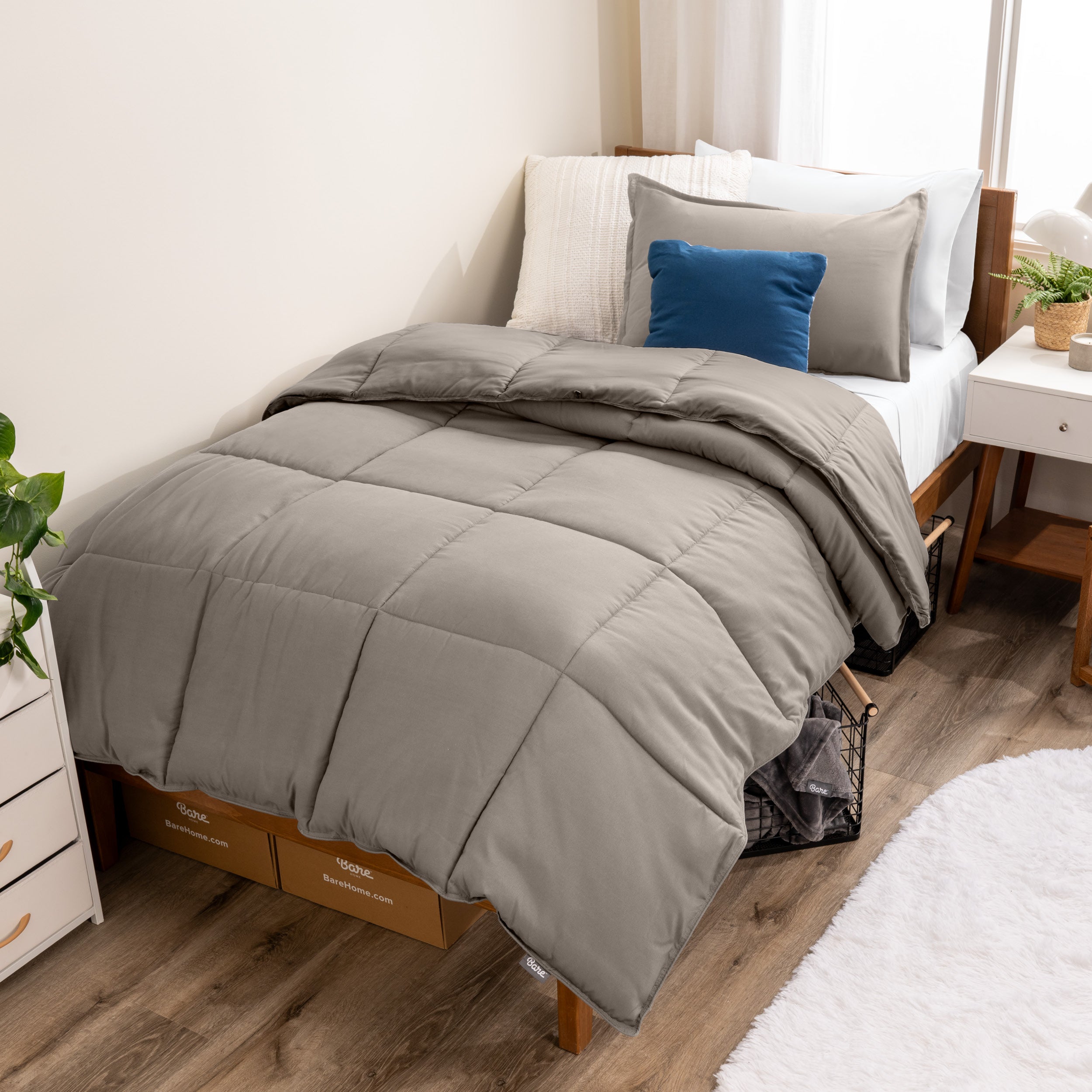 A modern bed with a down alternative comforter set on it