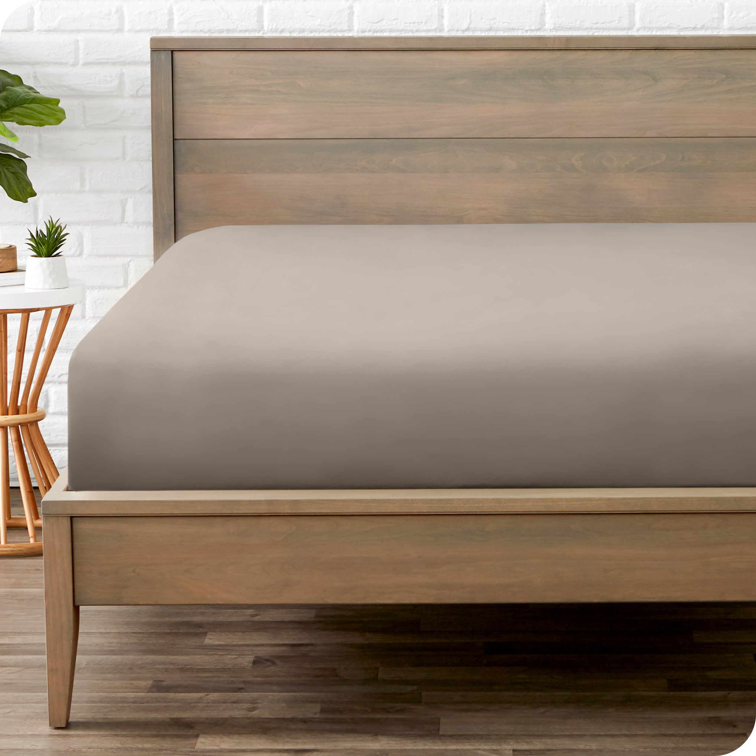 End of bed view with fitted sheet made on the mattress of a modern bed. 