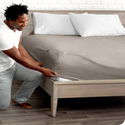 A man putting the microfiber fitted sheet on a mattress. 
