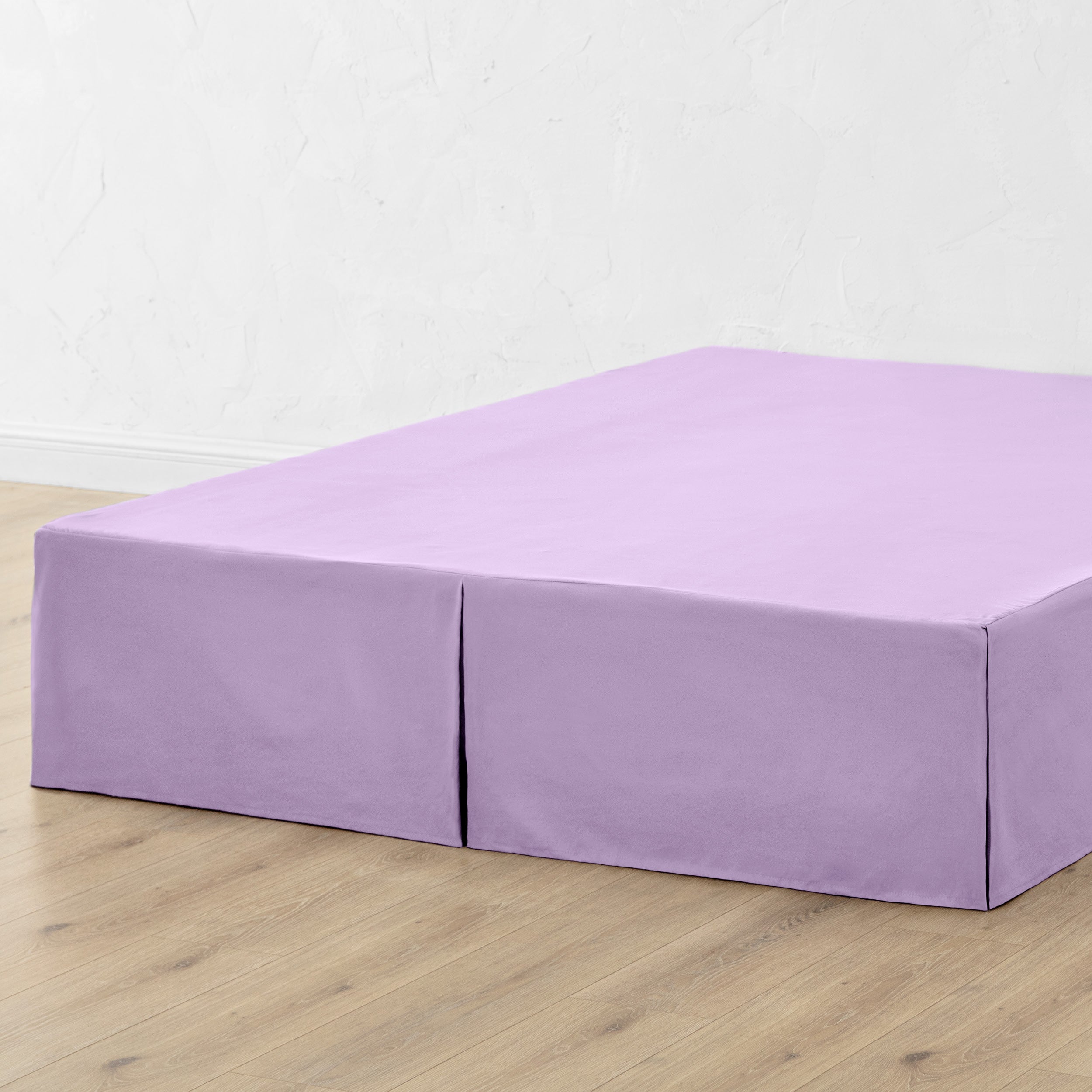 A bed skirt draped over a box spring