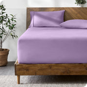 A modern bed with a fitted microfiber sheet made on the mattress. 