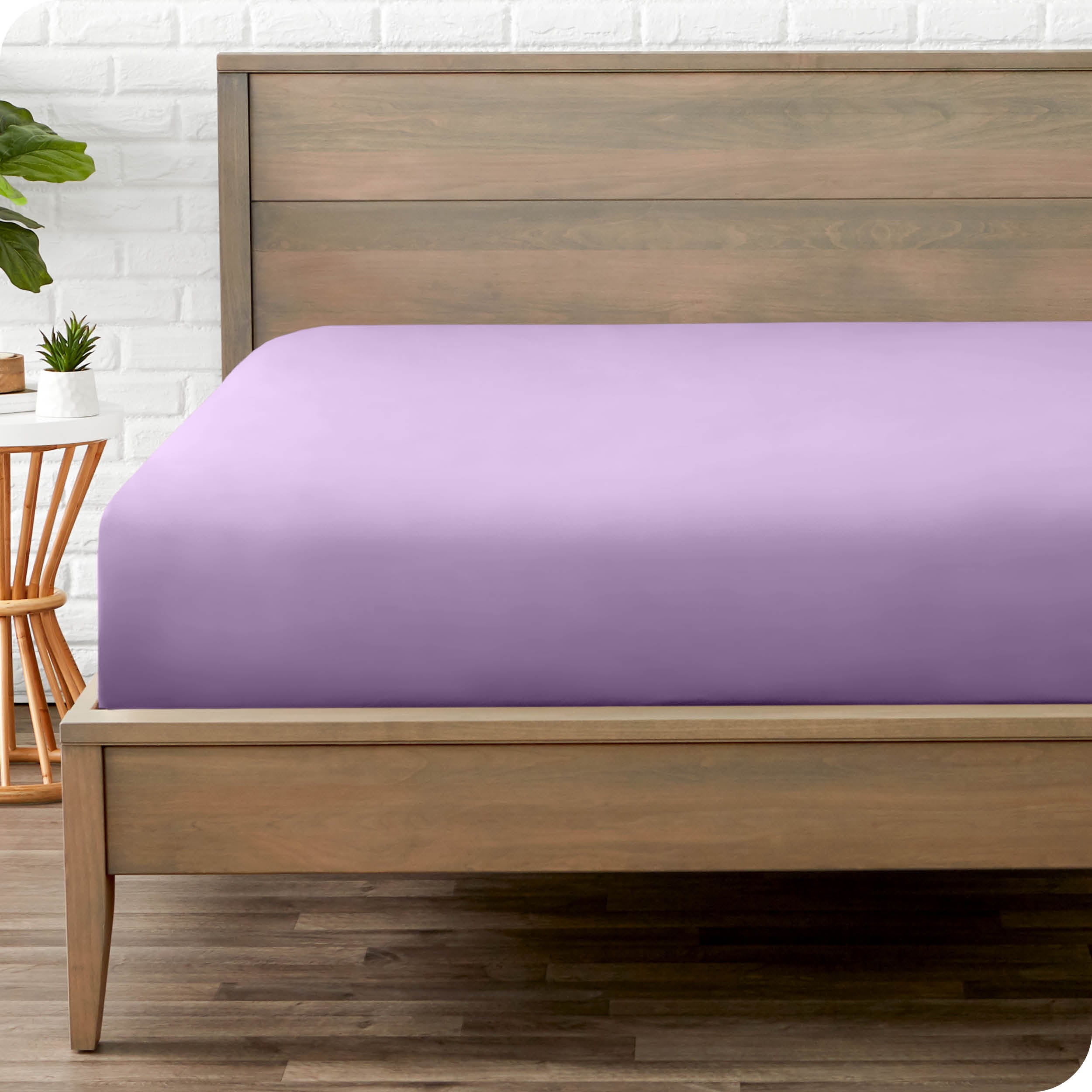 End of bed view with fitted sheet made on the mattress of a modern bed. 