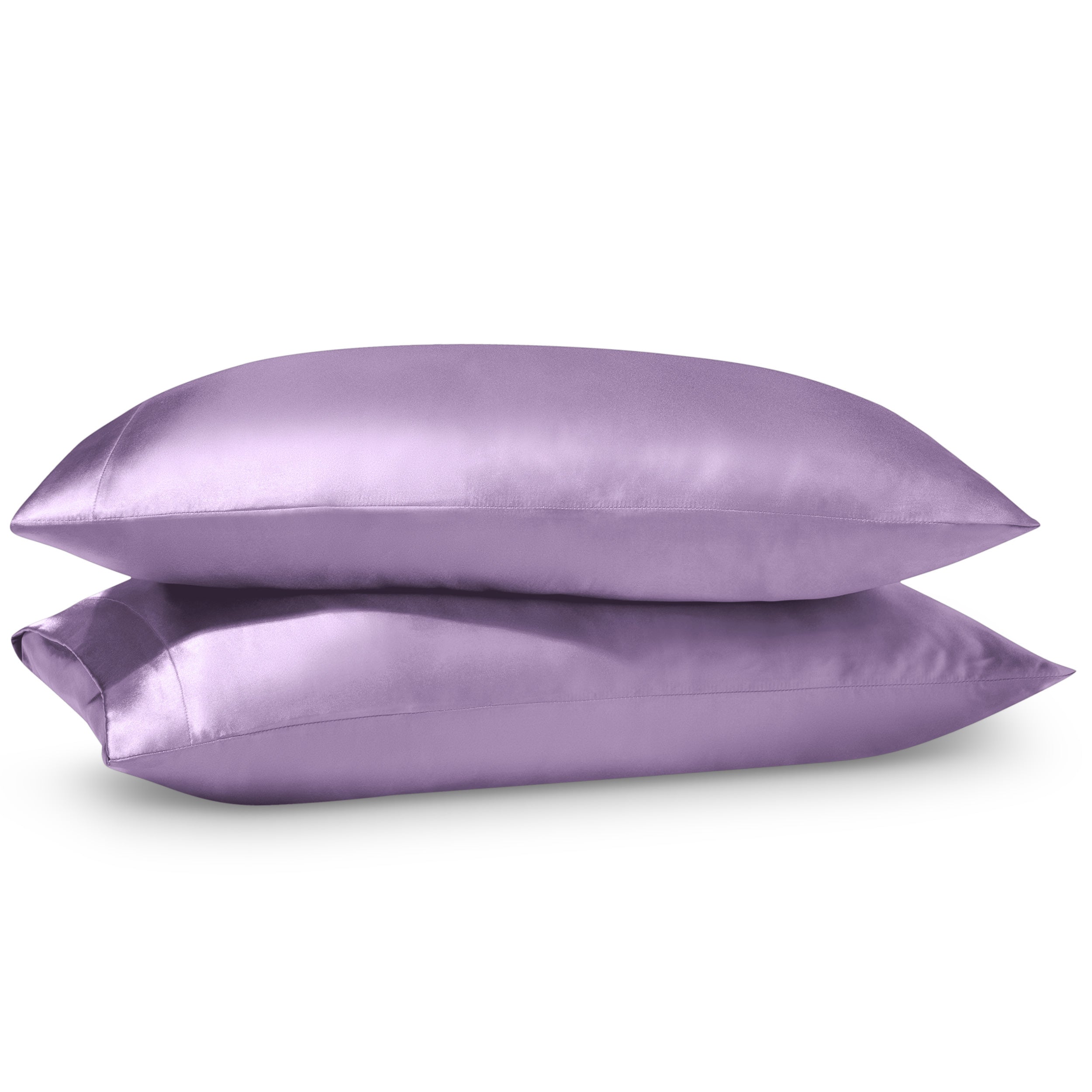 Two pillows on a white background with satin pillowcases on them.
