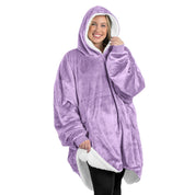 An adult with a sherpa wearable blanket on