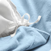 A folded stack of a flannel duvet cover with two pillows on top.