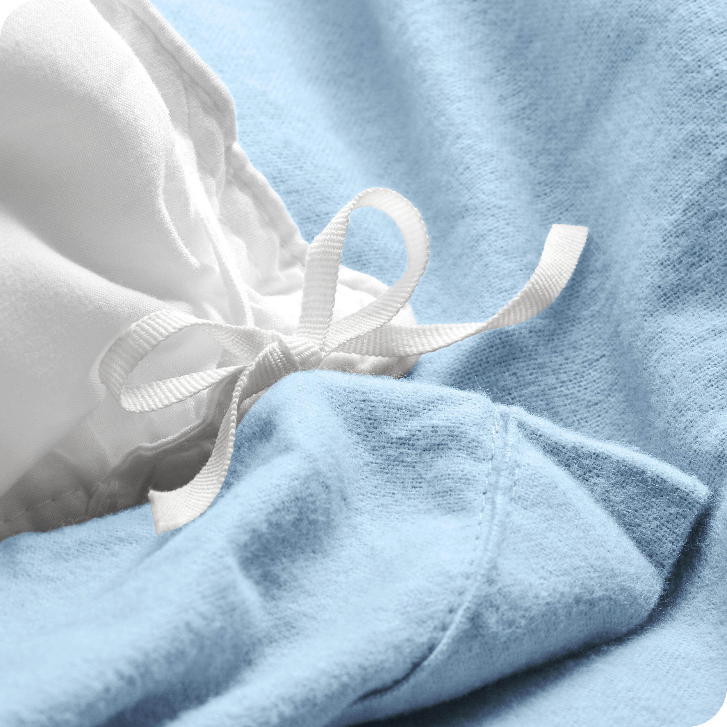 A folded stack of a flannel duvet cover with two pillows on top.