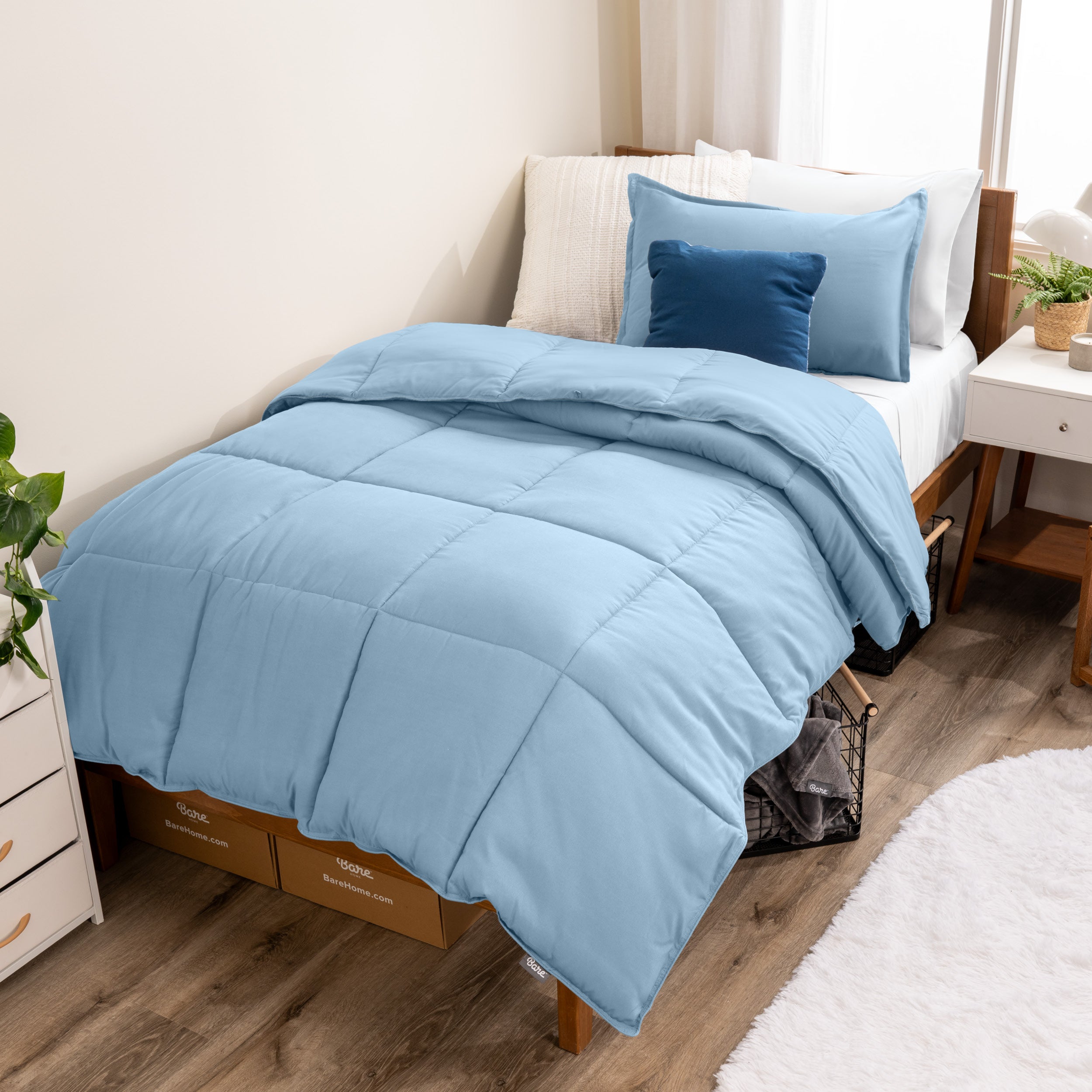 A modern bed with a down alternative comforter set on it