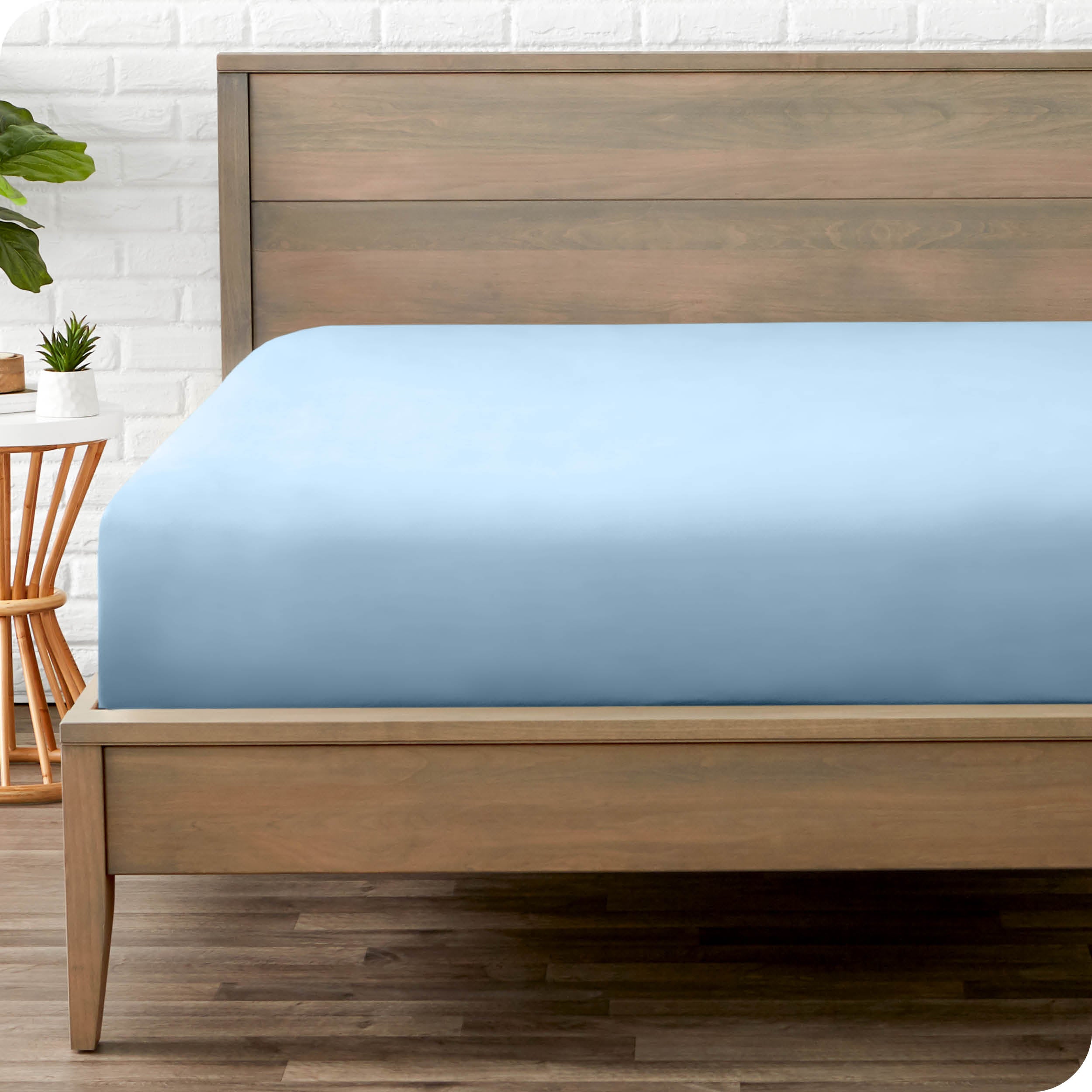 End of bed view with fitted sheet made on the mattress of a modern bed. 