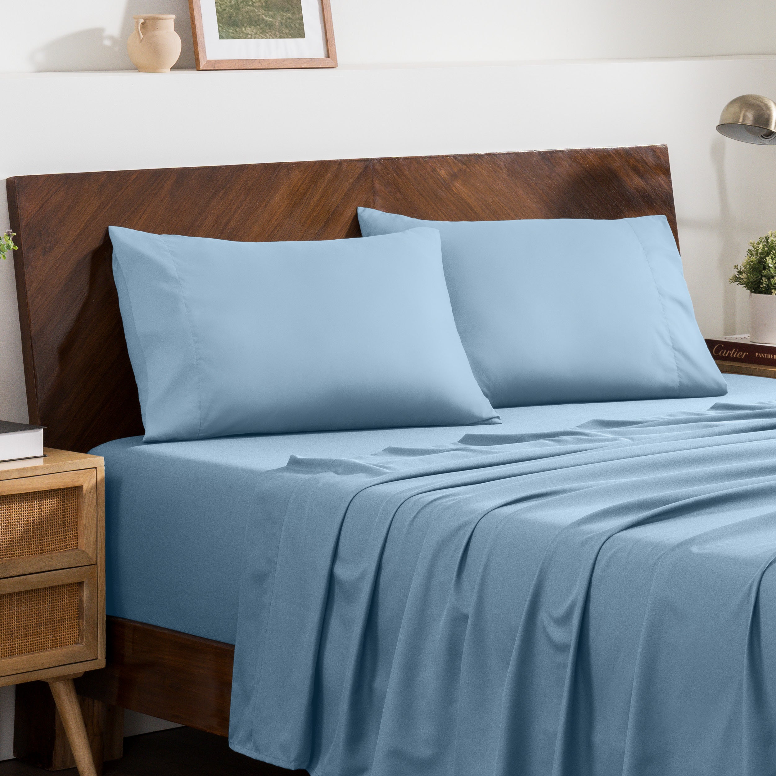 2 pillowcases on pillows on a nicely made bed