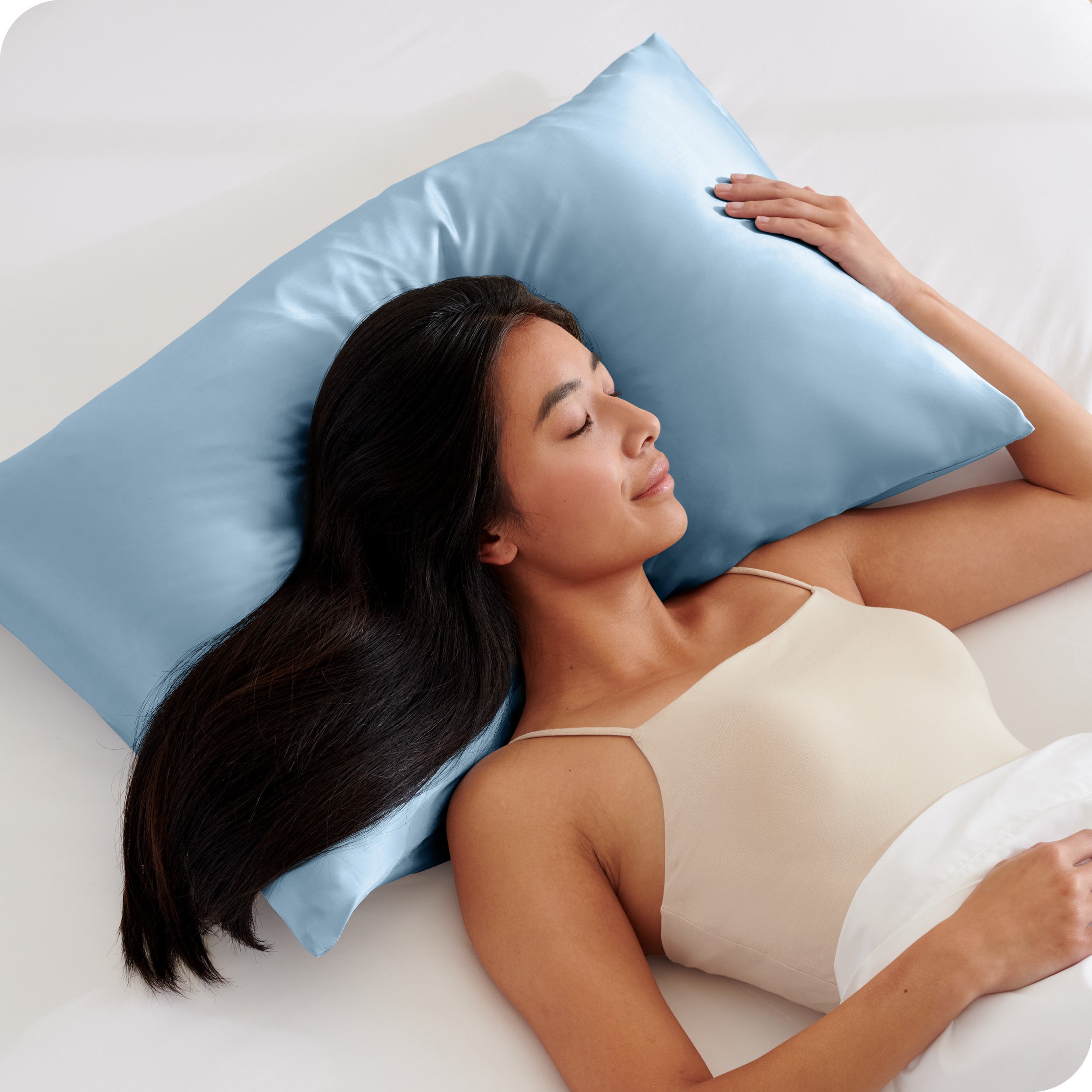 A woman sleeping on a silk pillowcase
