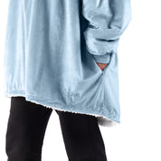 An adult with a sherpa wearable blanket on