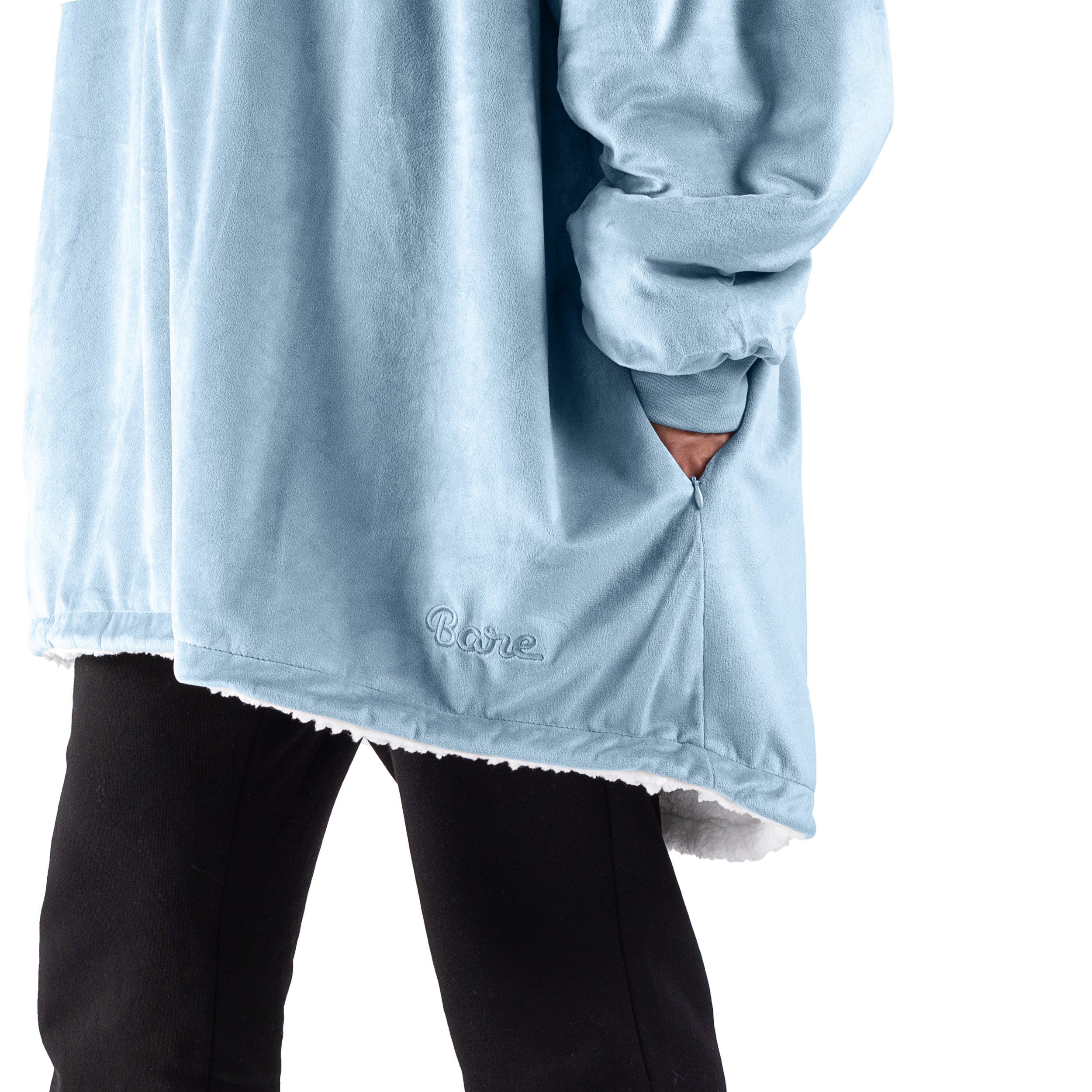 An adult with a sherpa wearable blanket on