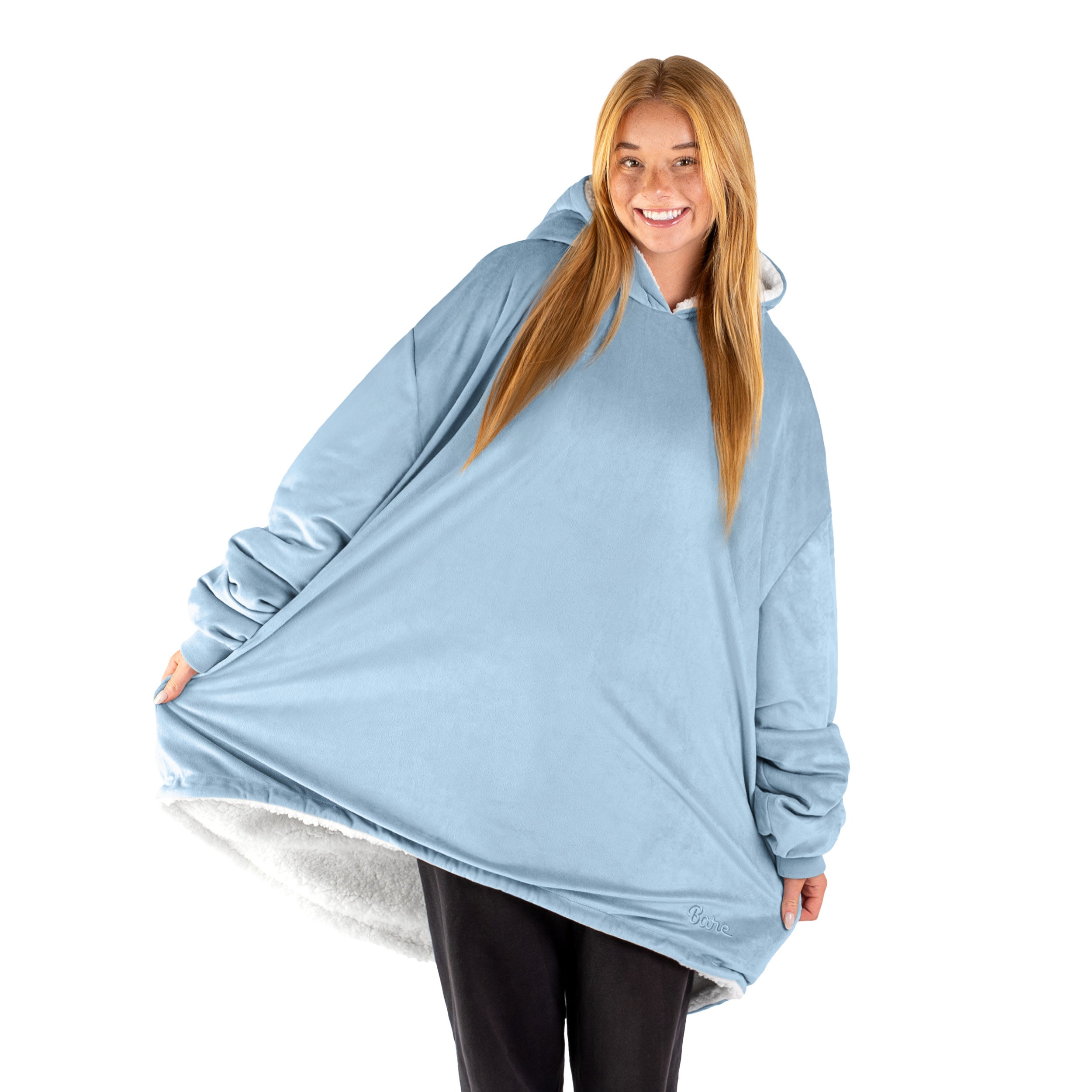 An adult with a sherpa wearable blanket on