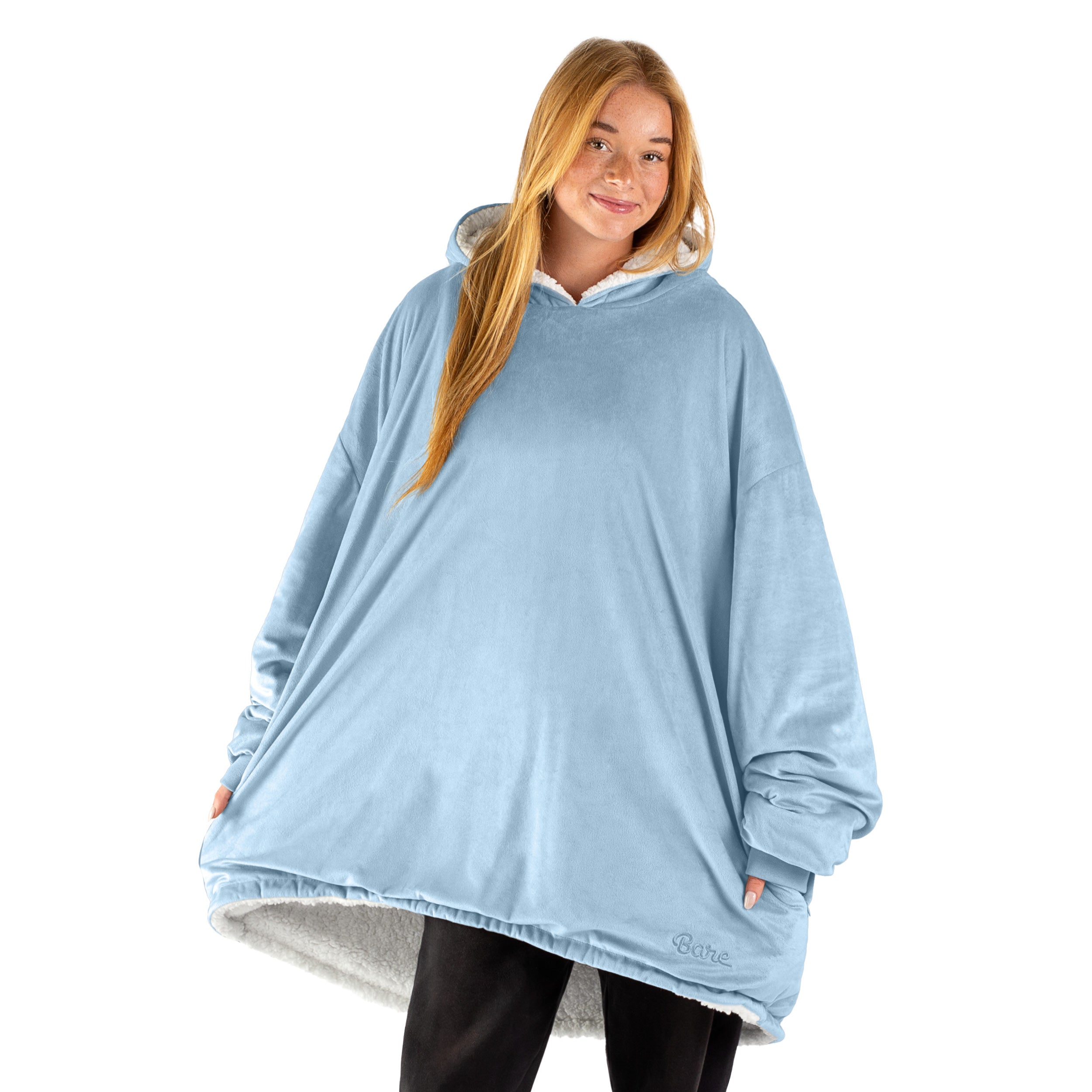 An adult with a sherpa wearable blanket on