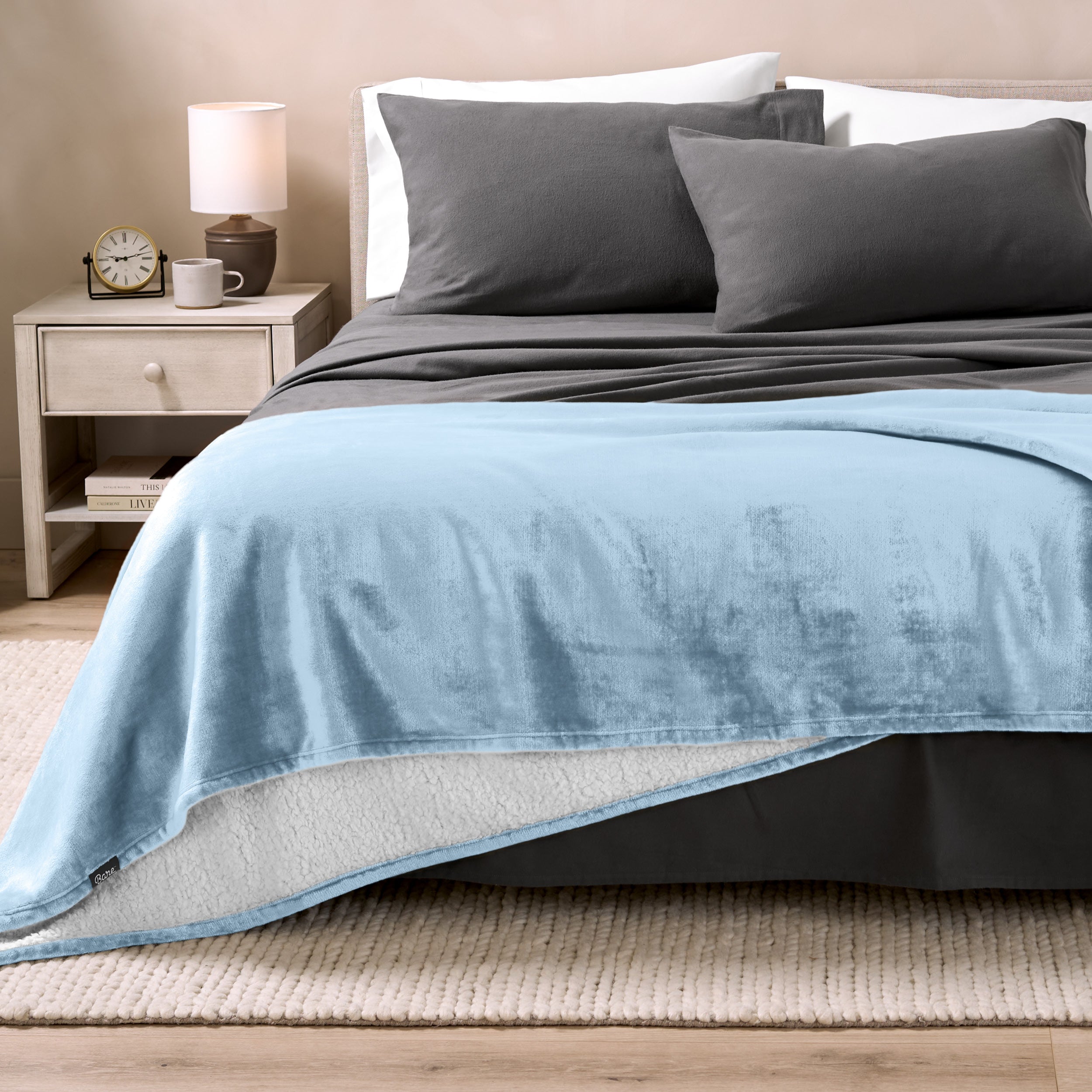 Sherpa Blanket laying on a bed folded over itself part way